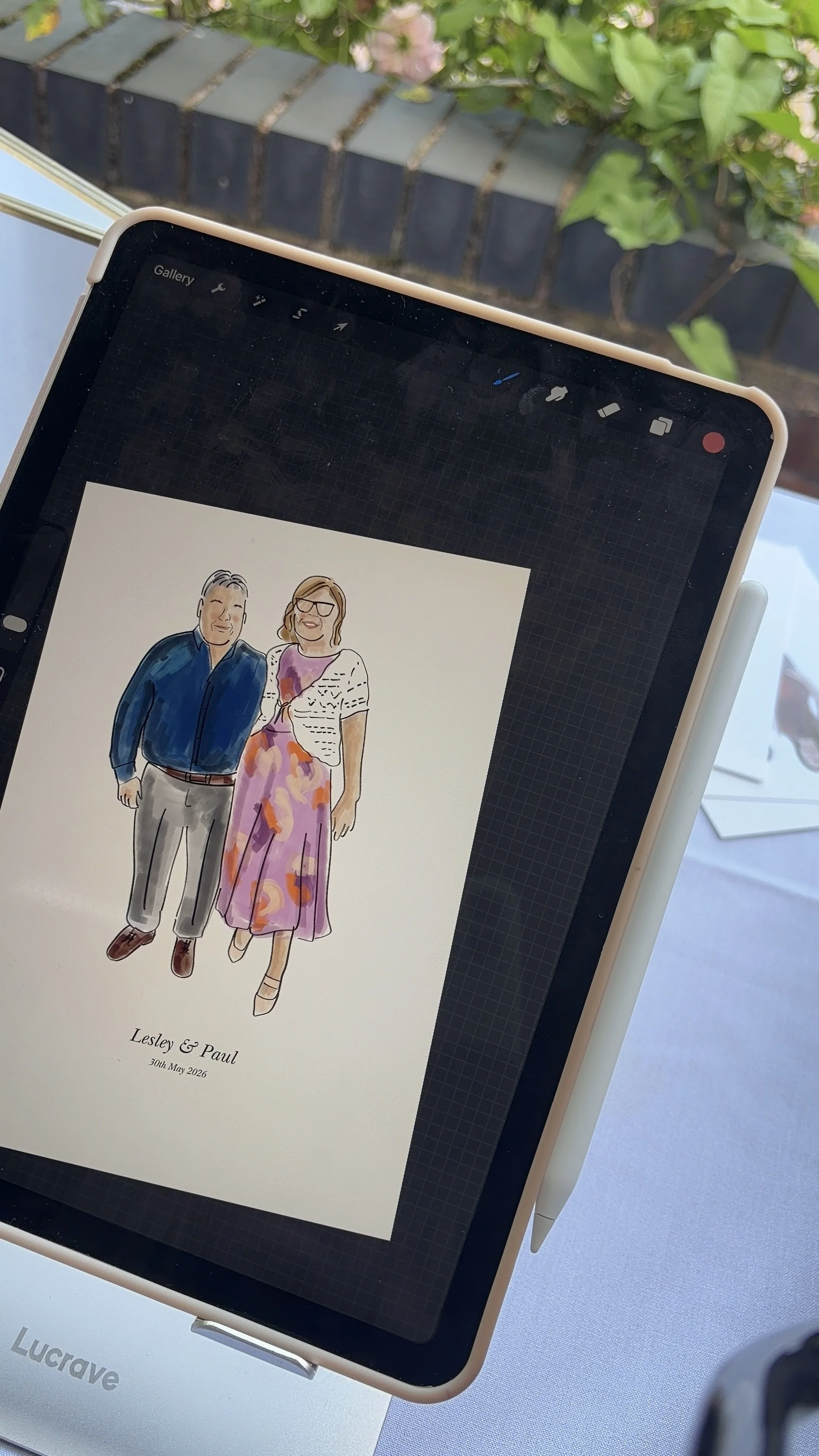 Watercolor illustration of a couple, a man and a woman, dressed in formal attire, standing together and smiling. The text below reads "Lesley & Paul, 30th May 2026."
