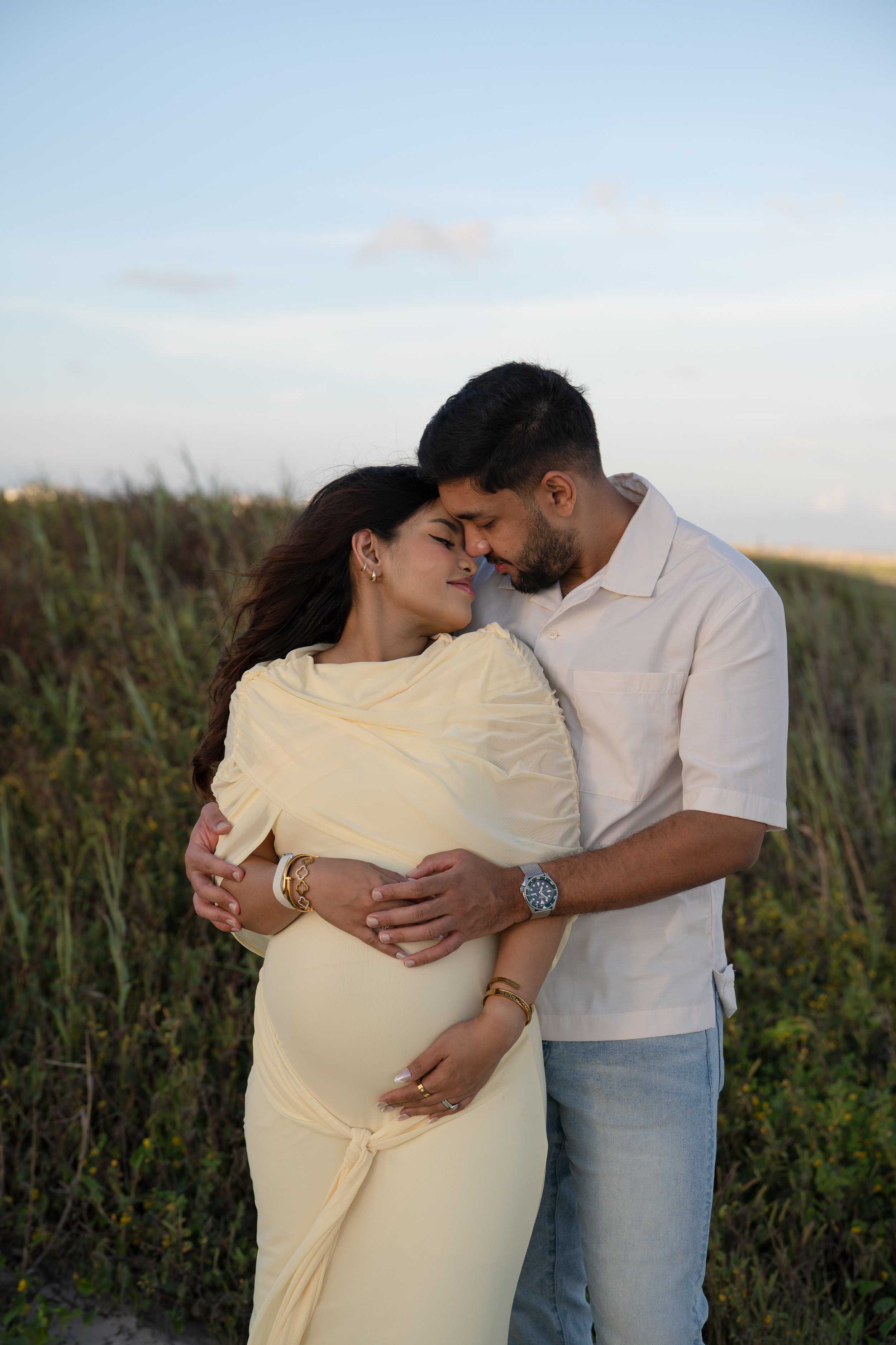 galveston beach houston couple embracing maternity belly at the beach