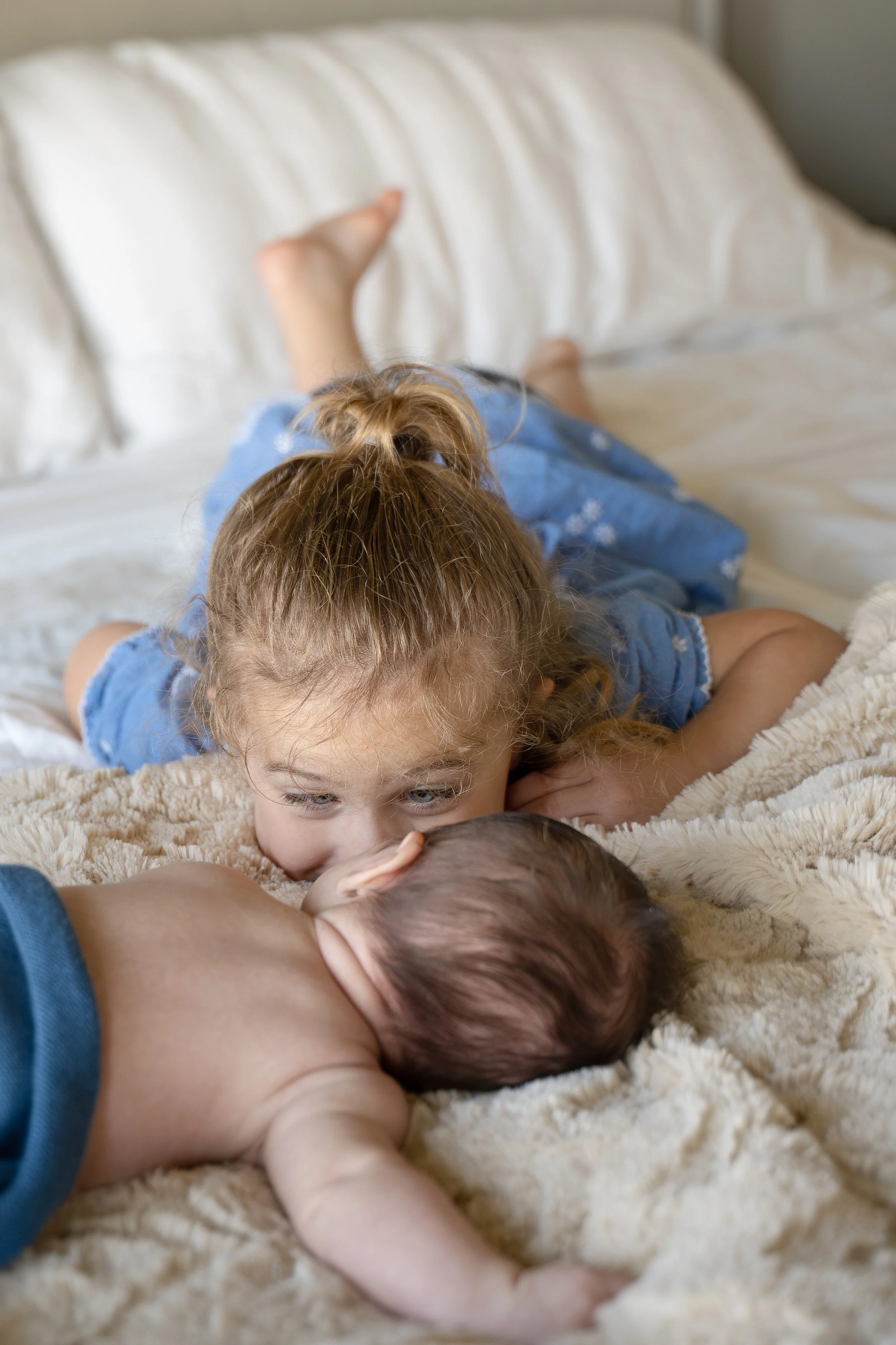 the woodlands toddler playing with newborn at home