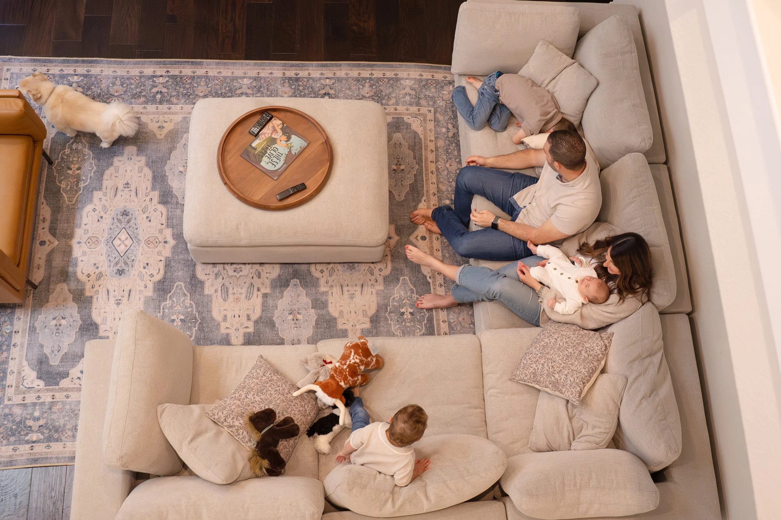 Sienna Houston family cuddling on the couch at home with mom, dad, two older brothers & newborn baby boy