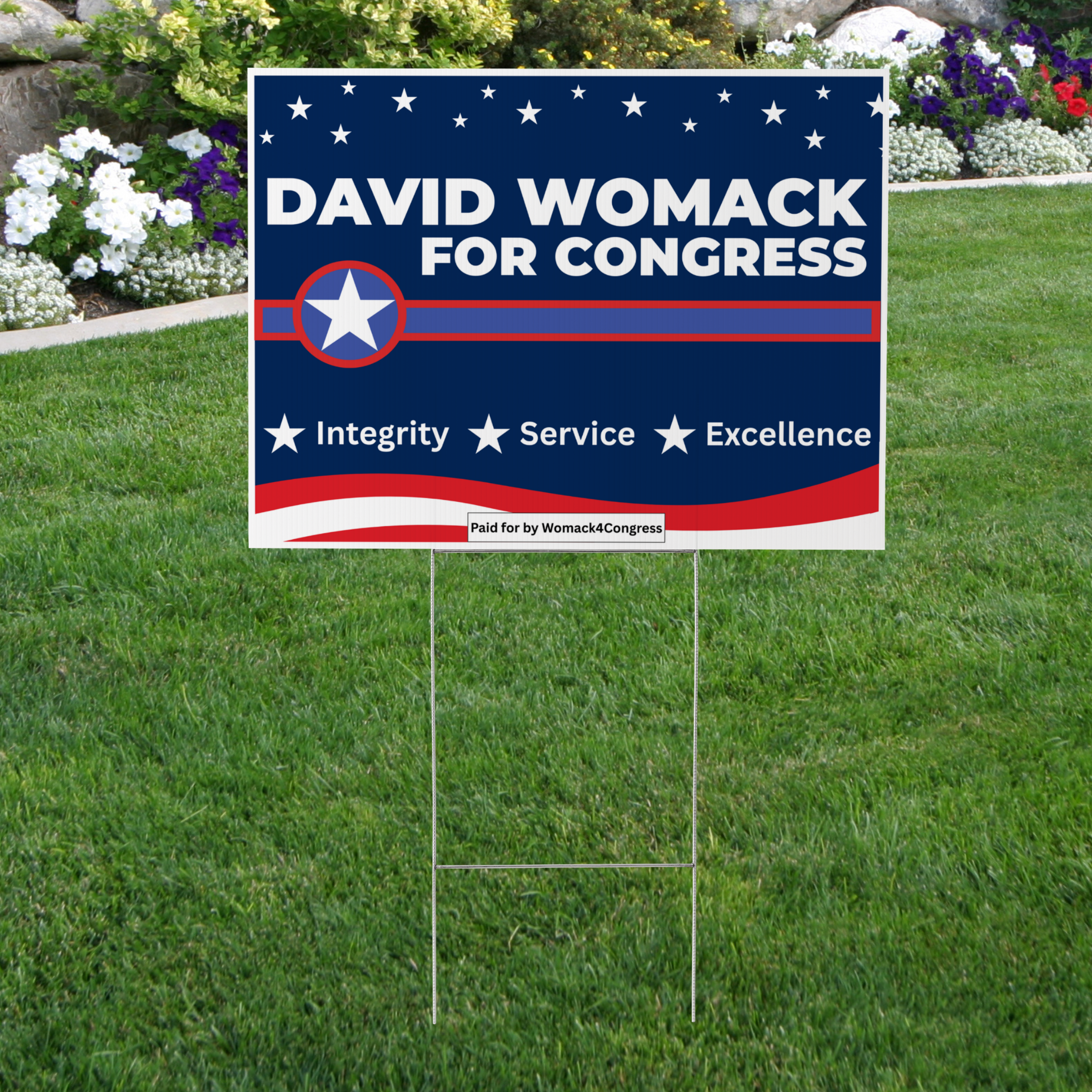 A political campaign yard sign for David Womack, running for Congress, featuring a patriotic red, white, and blue design with stars and stripes, and the words 'Integrity,' 'Service,' and 'Excellence'.
