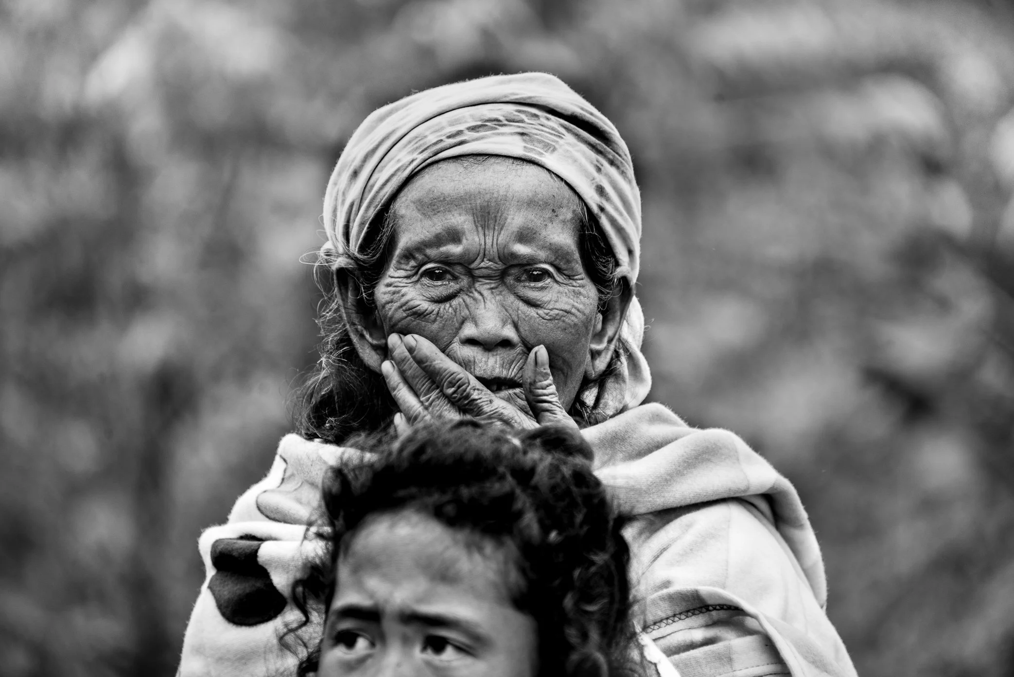 Attapeu, Laos - A survivor of the Xe Pian dam collapse stands in a state of shock and loss after the disaster. In her face is the weight of what many survivors carried in the days that followed - fear, displacement, uncertainty, and the sudden breaki