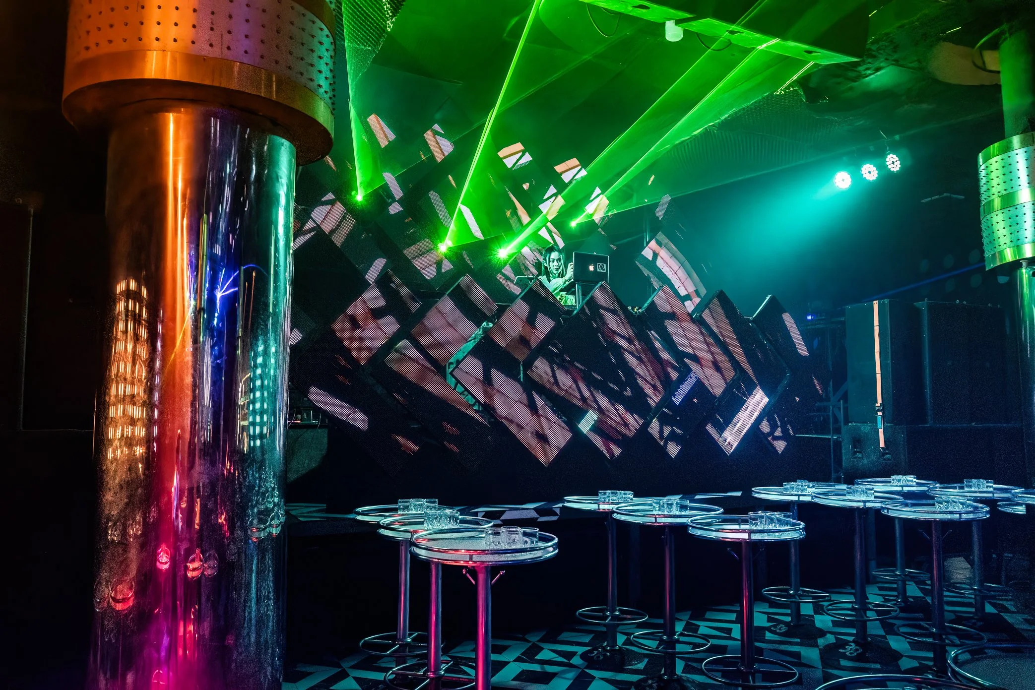 Pakse, Laos, 2022 - Inside a nightclub in Pakse, empty tables sit beneath laser lights and a silent stage. As the Lao kip weakens, some entertainment venues have shifted into the hands of foreign investors with stronger purchasing power than many loc