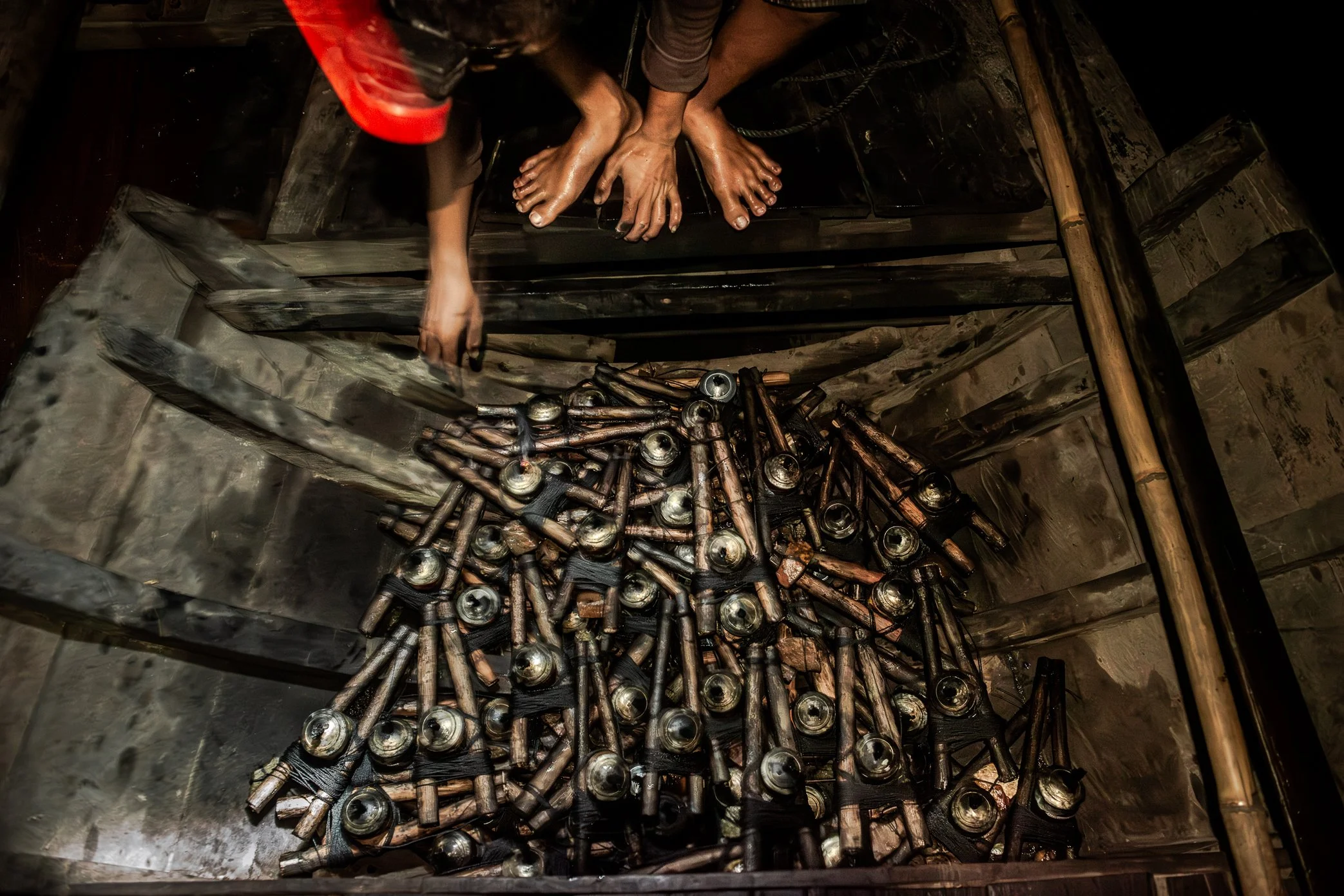 Tonle Sap, Cambodia - At night’s end on Tonle Sap, fishermen collect their oil lamps before heading back to shore. The tools of an illegal fishing method are packed away quietly - evidence of a life shaped by necessity, and of a lake under growing pr