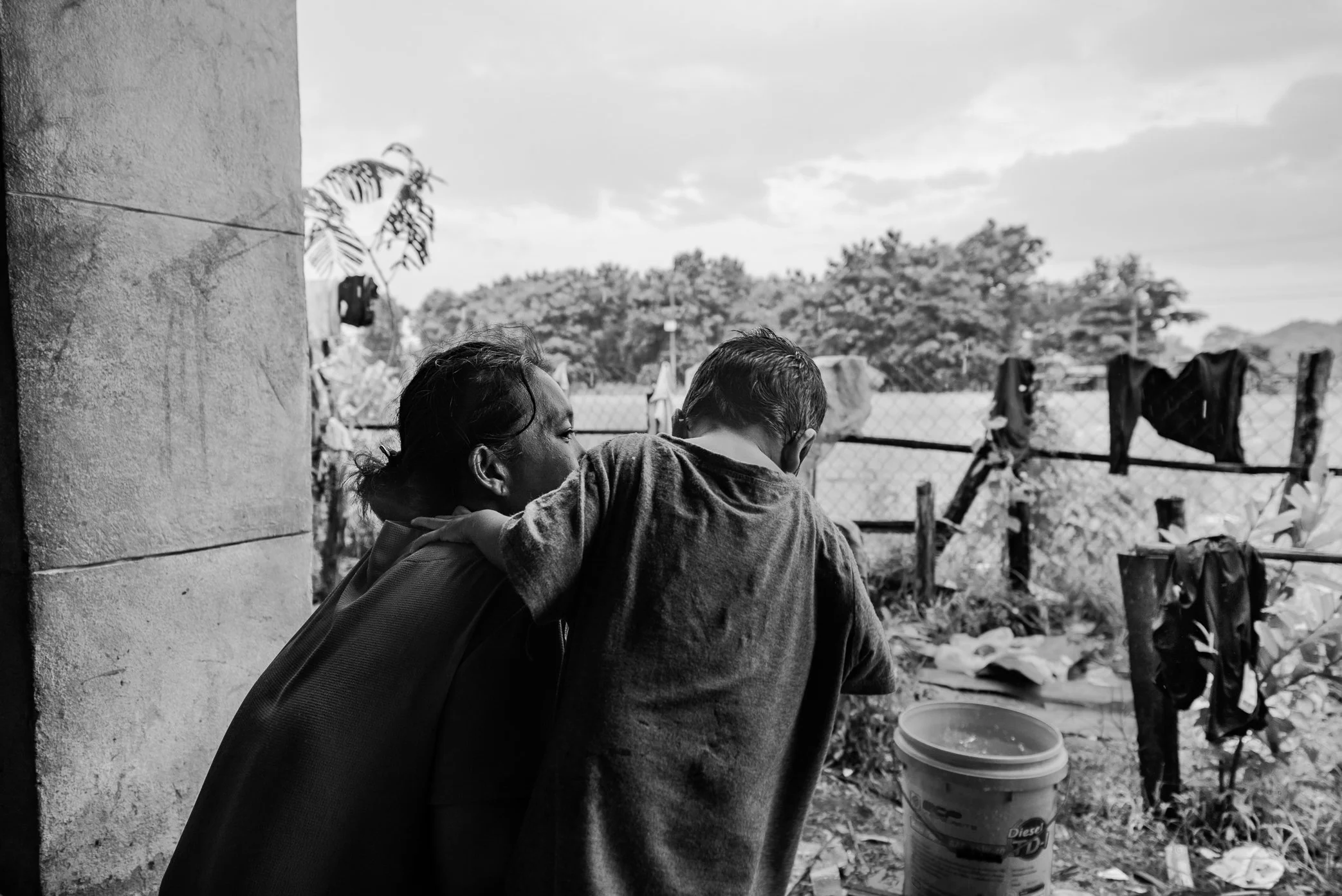 Tamoyot Shelter, Attapeu, Laos - A displaced survivor from Hin Lat holds a child at the Tamoyot relief shelter after the Xe Pian dam collapse. For nearly 95 percent of the families here, there was no home left to return to. The flood had swept away h