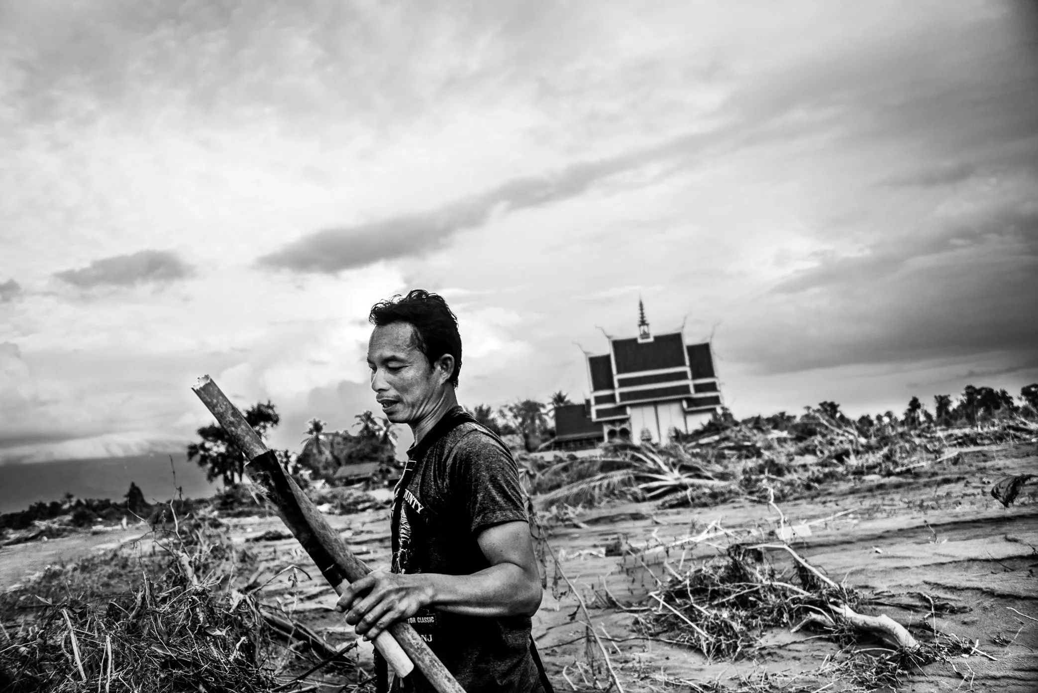 Hin Lat Village, Attapeu, Laos - A survivor returns to search for belongings after the Xe Pian dam collapse swept away homes and property in Hin Lat. Before the disaster, the village had around 180 households. Fewer than 10 houses remained standing a