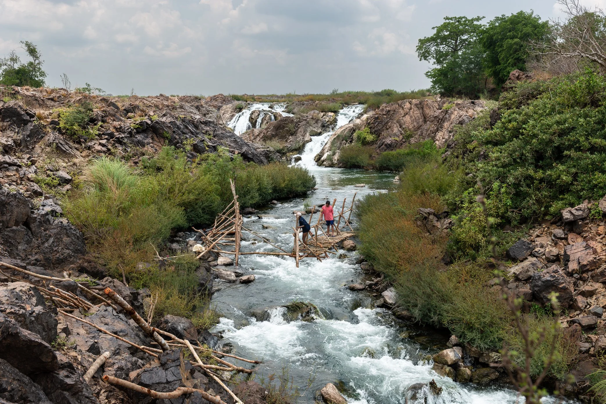 By April, when the Mekong falls to its dry-season level, fishermen in Si Phan Don begin building their li traps across the rocky channels. The work must be completed before the rains arrive, the river rises, and the annual migration of fish begins mo