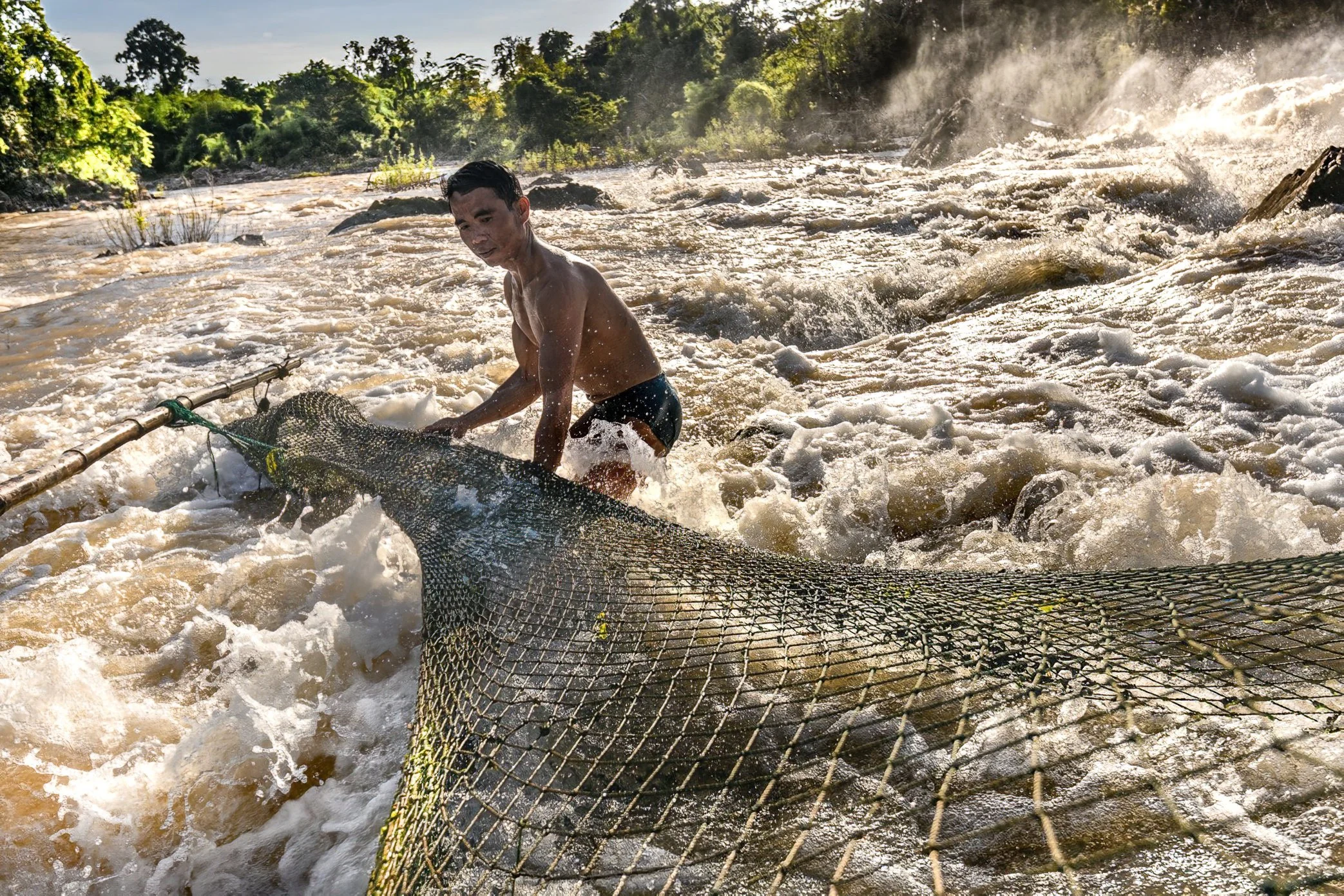 In Si Phan Don, fishing continues even in the shifting weeks between the dry season and the first rains. As the Mekong begins to change, fishermen use different tools for different waters - nets, traps, bamboo frames, and hand-built structures placed