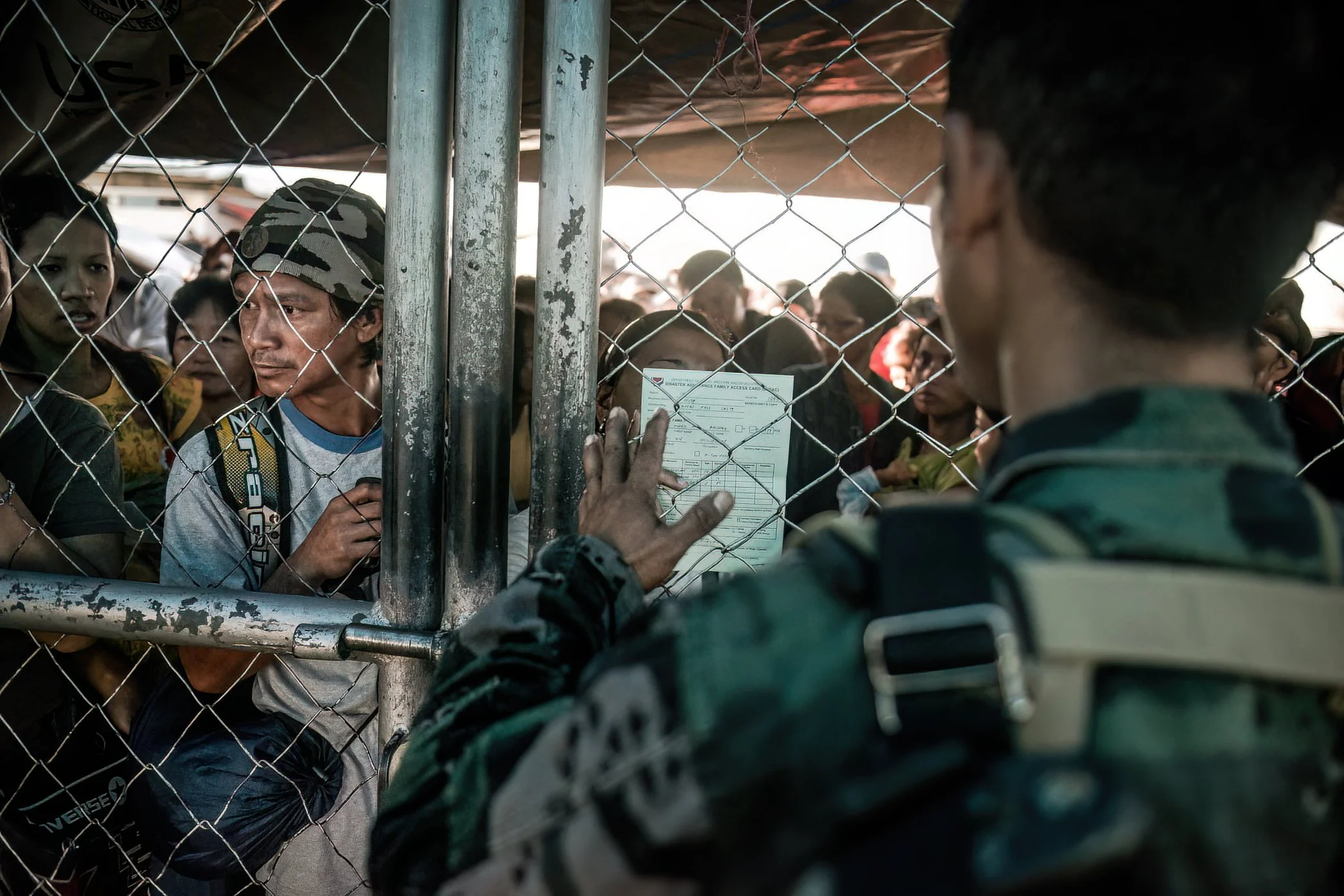 Tacloban airport. Hundreds of people struggle to evacuate. Exhausted and stressed soldiers try to maintain control.