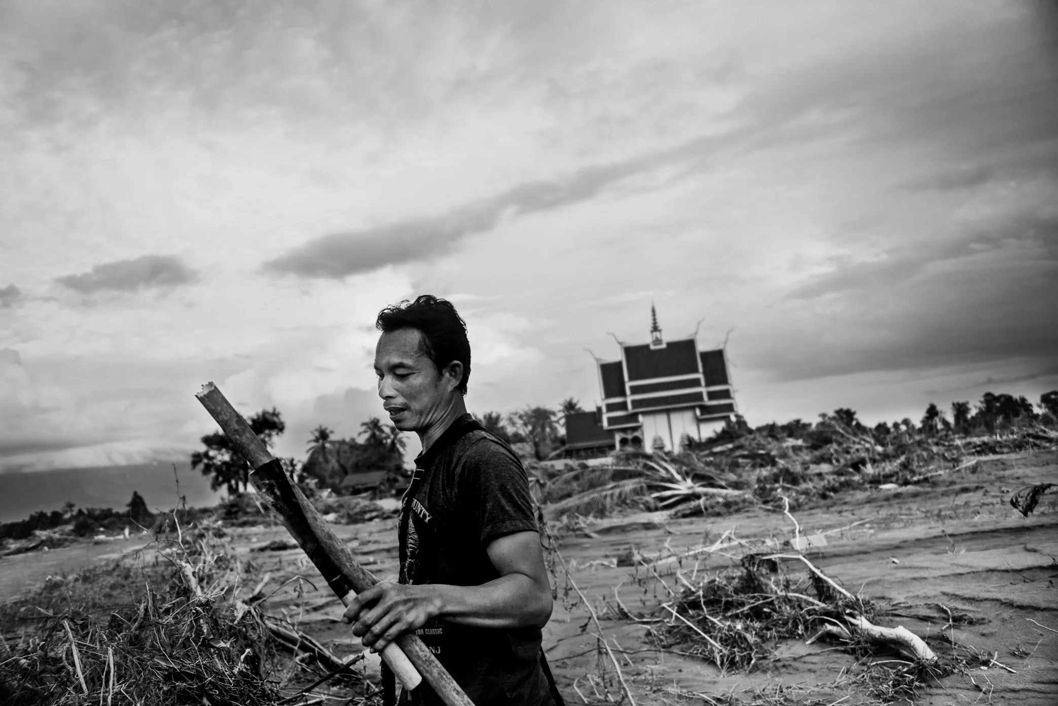 Hin Lat Village, Attapeu, Laos - A survivor returns to search for belongings after the Xe Pian dam collapse swept away homes and property in Hin Lat. Before the disaster, the village had around 180 households. Fewer than 10 houses remained standing a