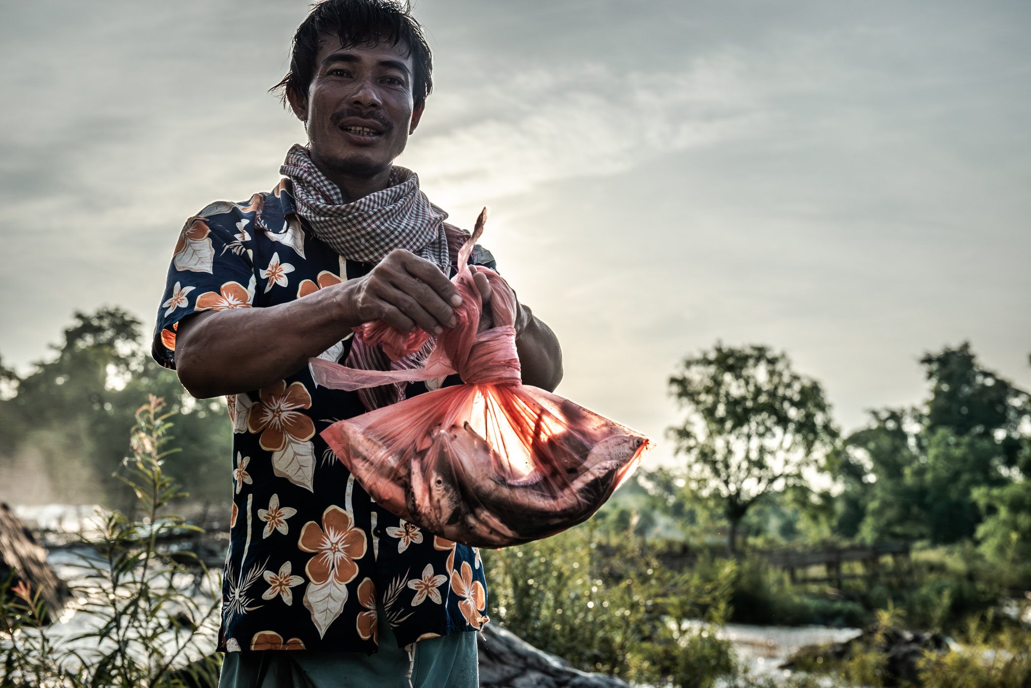 Each morning, fishermen in Si Phan Don return to their traps to see what the river has yielded overnight. Before the great migration begins - while the Mekong is still relatively low and the main runs have yet to arrive - the catch is often limited t
