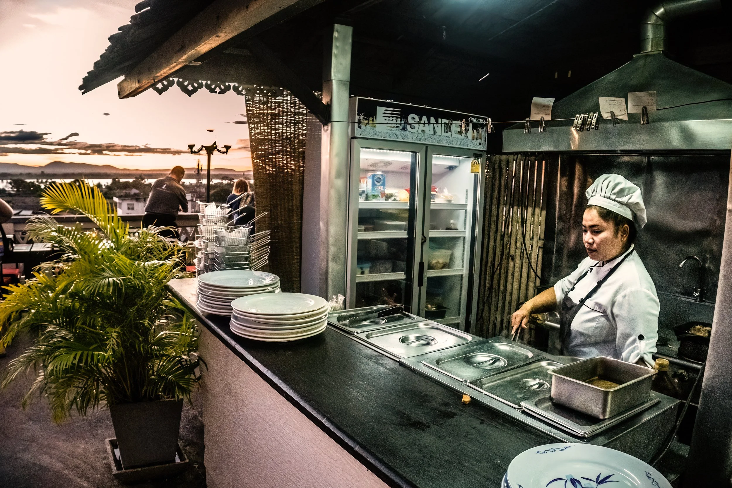 Pakse, Laos, 2022 - A hotel kitchen prepares for evening service as foreign tourists slowly return to southern Laos. But the recovery is uneven. As the kip weakens and operating costs rise, small tourism businesses struggle to know whether visitors c