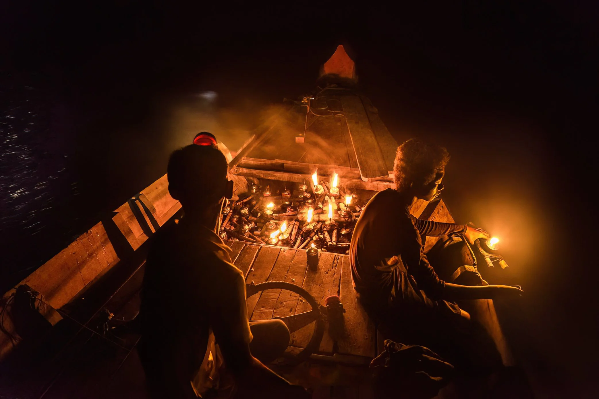 Oil Lamp Fishing, Tonle Sap, Cambodia - On the Tonle Sap, some fishermen still work deep into the night using oil lamps to draw life toward the boat.

The flame attracts insects, the insects draw fish, and the water beneath the light becomes a small,