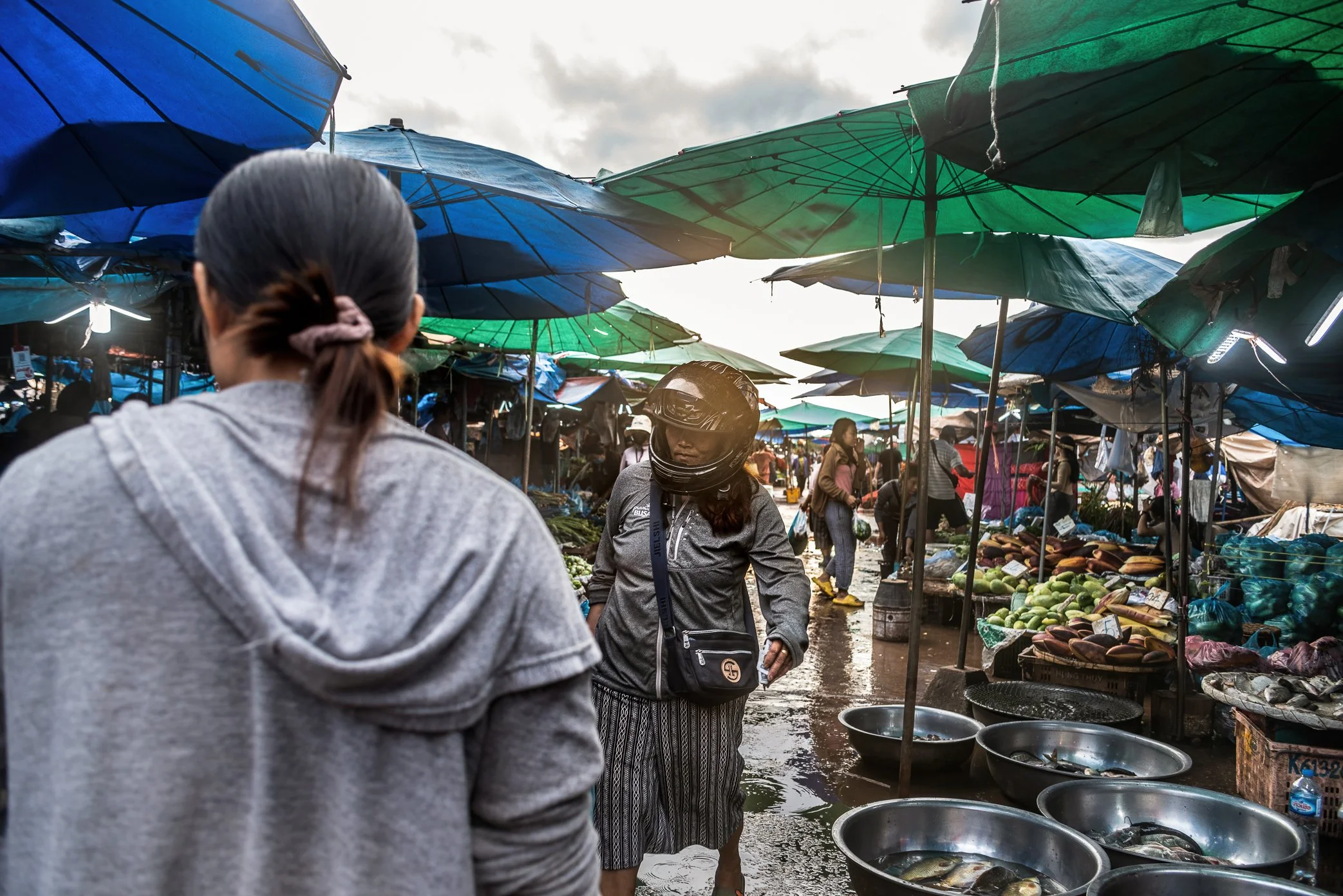 Vientiane, Laos, 2022 - Shoppers move through Oxy wholesale fresh market on the outskirts of Vientiane, once a busy source of produce and daily goods for traders, restaurant owners, and small shopkeepers. As fuel prices rose and the Lao kip weakened 