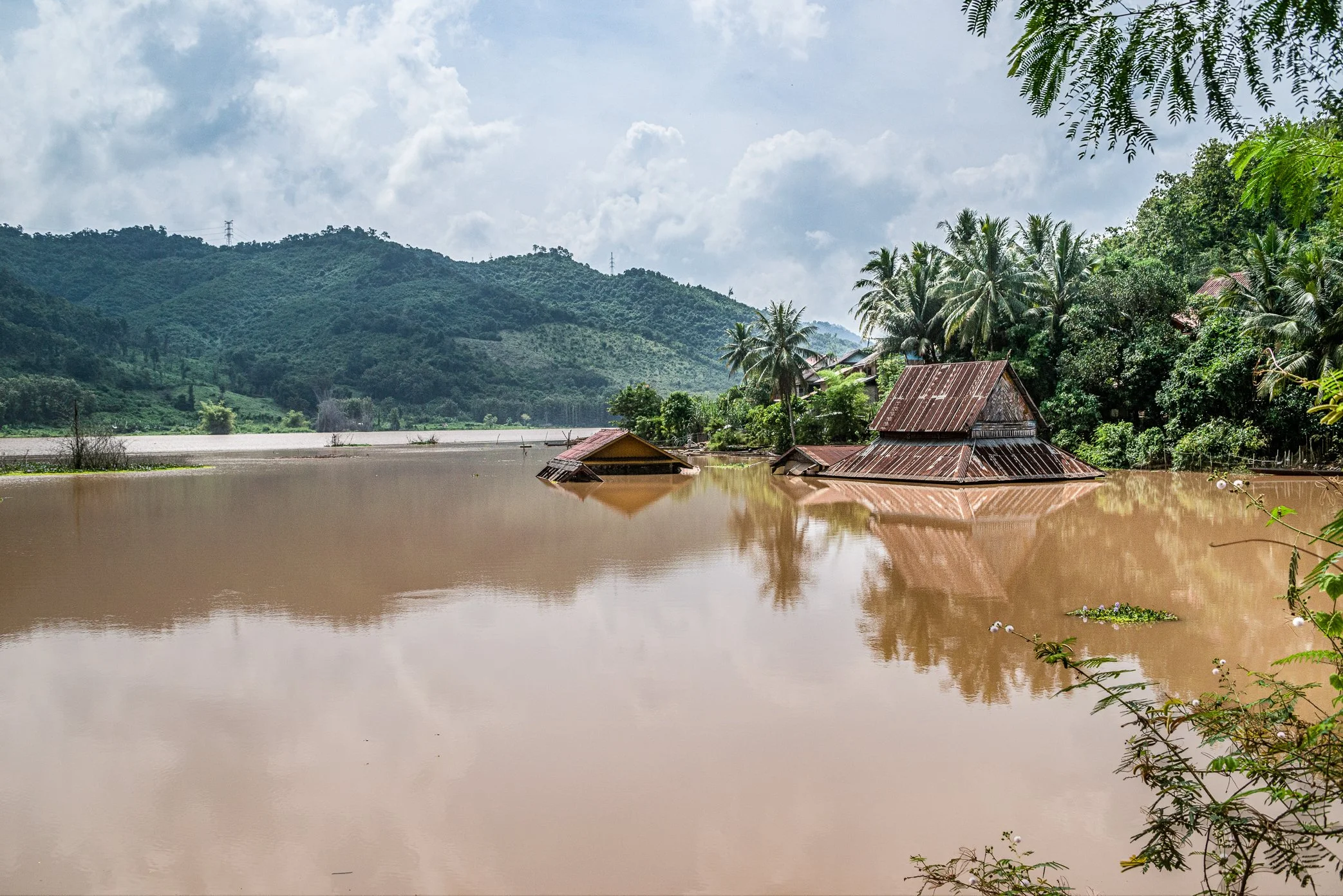 The old Sai Lom Yen temple stands partly submerged in the reservoir created by the Nam Ou dam, before the community was fully relocated.

Once built on dry ground beside the river, the temple became one of the village landmarks swallowed by rising wa