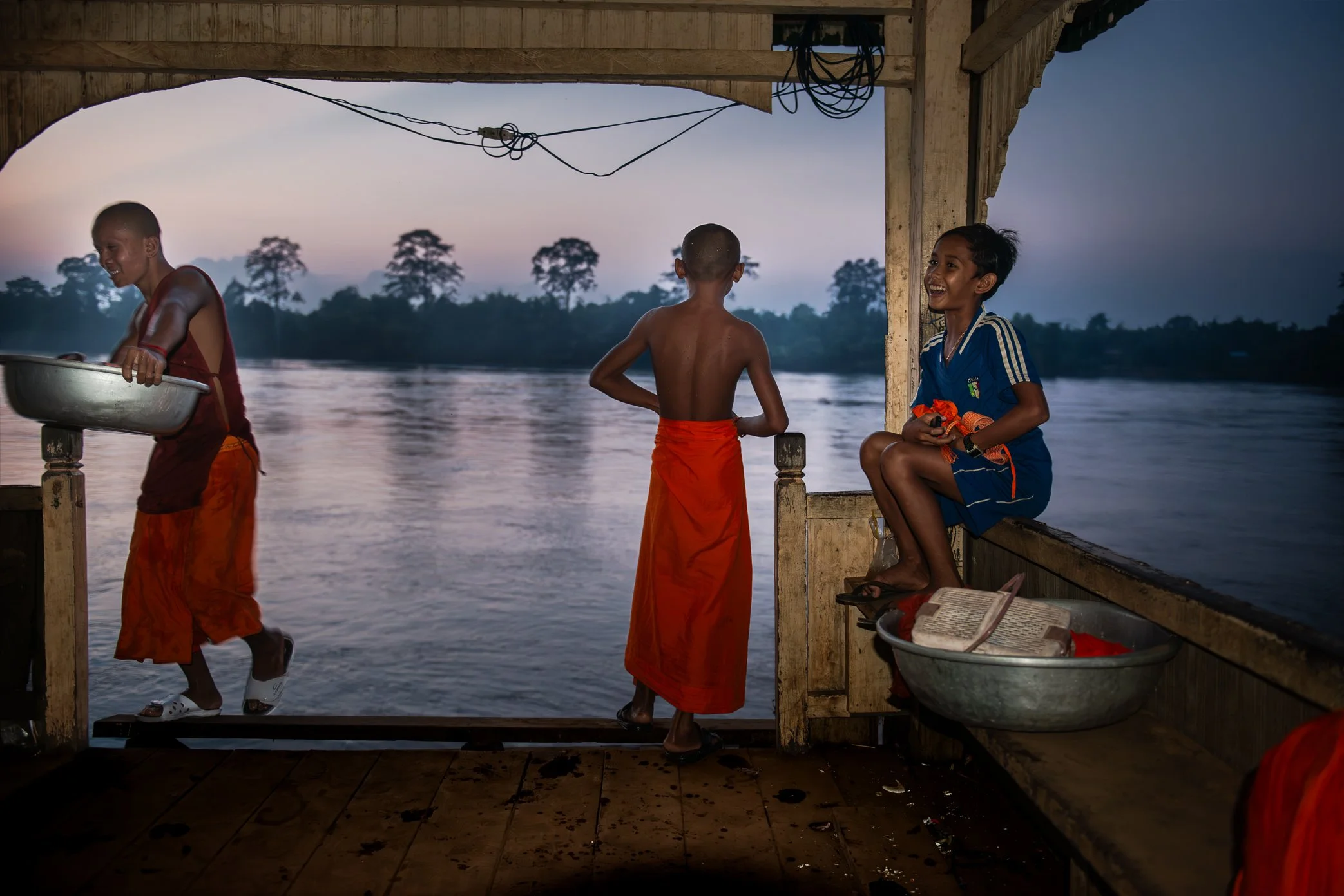 Novice monks move through daily life at a village temple near the Sesan River in northeastern Cambodia, before the area was transformed by the Lower Sesan 2 Dam. For communities such as Srekor and nearby villages, the loss was not measured only in ho