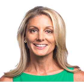 Portrait of a smiling woman with blonde hair, wearing a green top and gold hoop earrings.