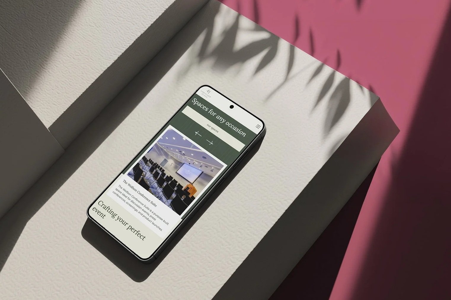 Smartphone displaying a website for event spaces, showing a conference room and text about crafting the perfect event.