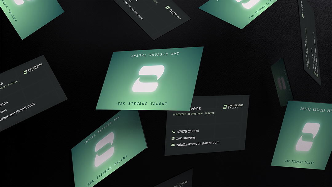 Multiple business cards floating in midair with the logo and contact information for Zak Stevens Talent, a recruitment service.
