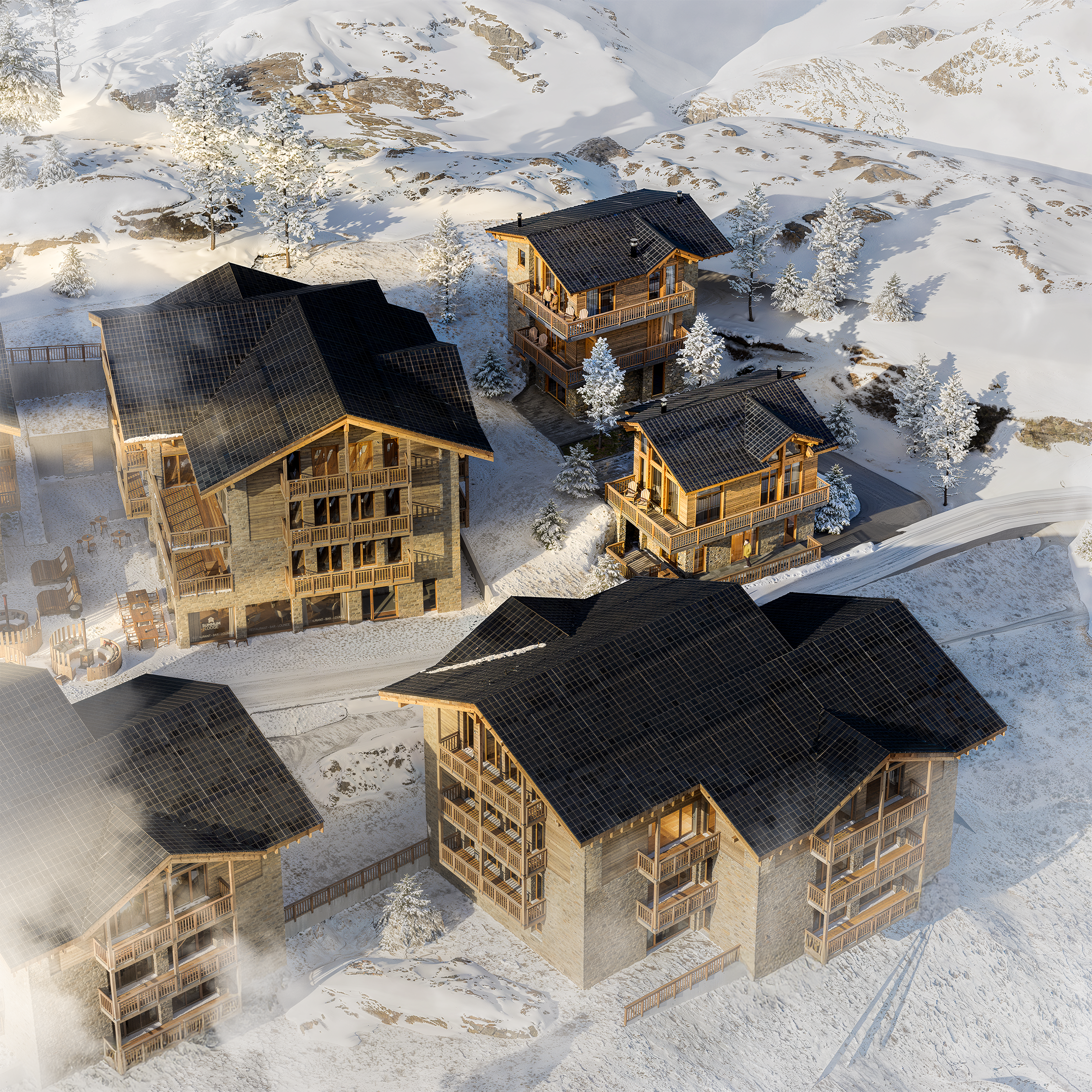 Luchtfoto van een besneeuwd bergdorp met houten chalets en bomen in de winter, omgeven door bergen.
