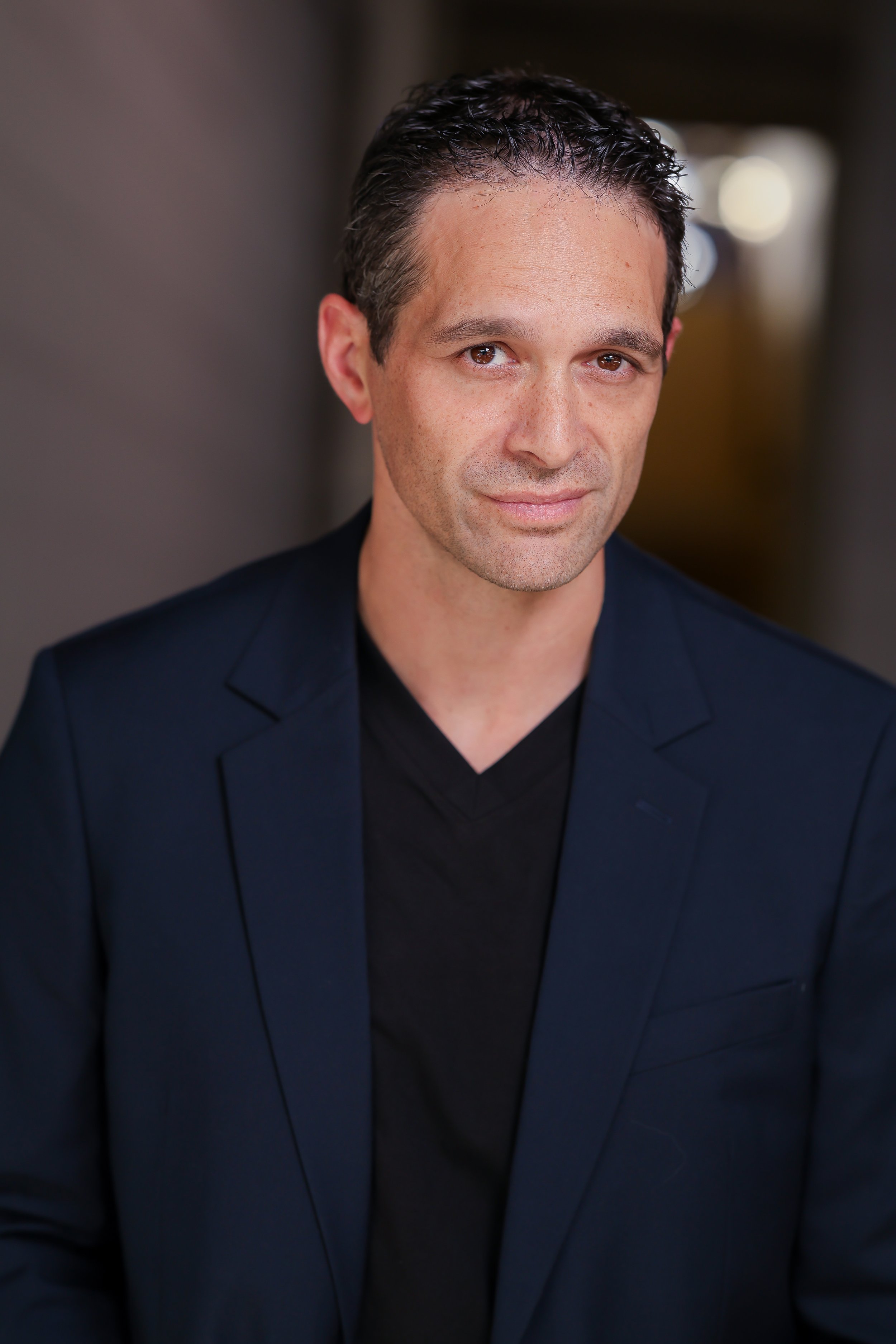 Michael Deed wearing a navy blazer.