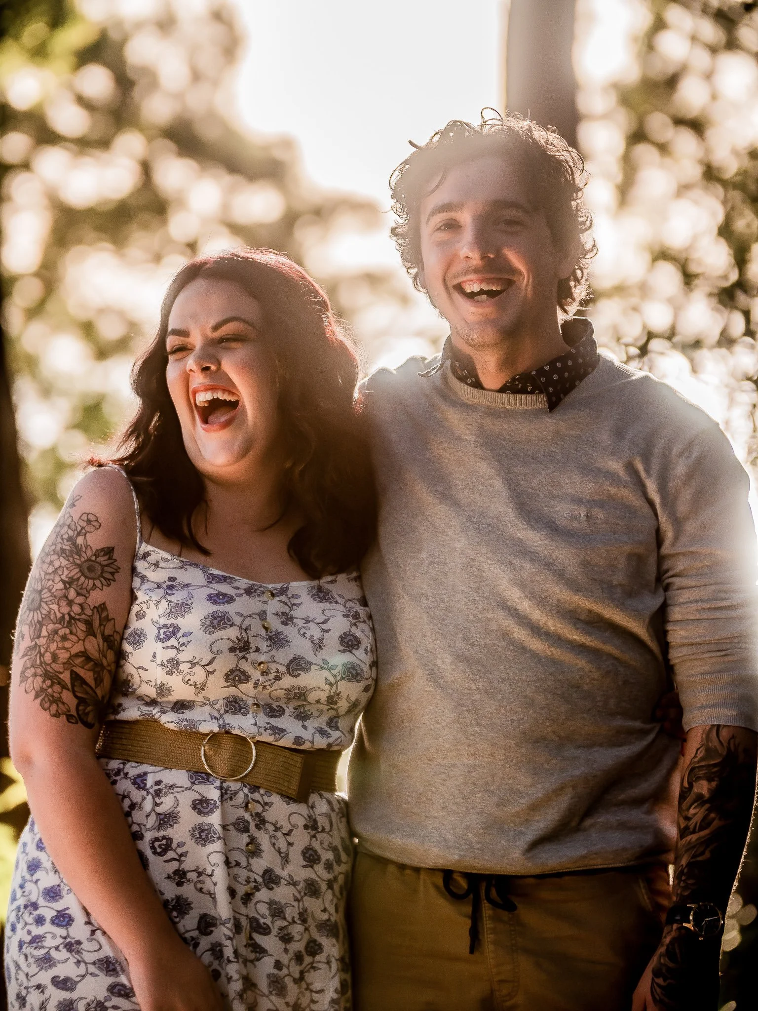 1️⃣ Laughing couple standing together (sun flare).jpg