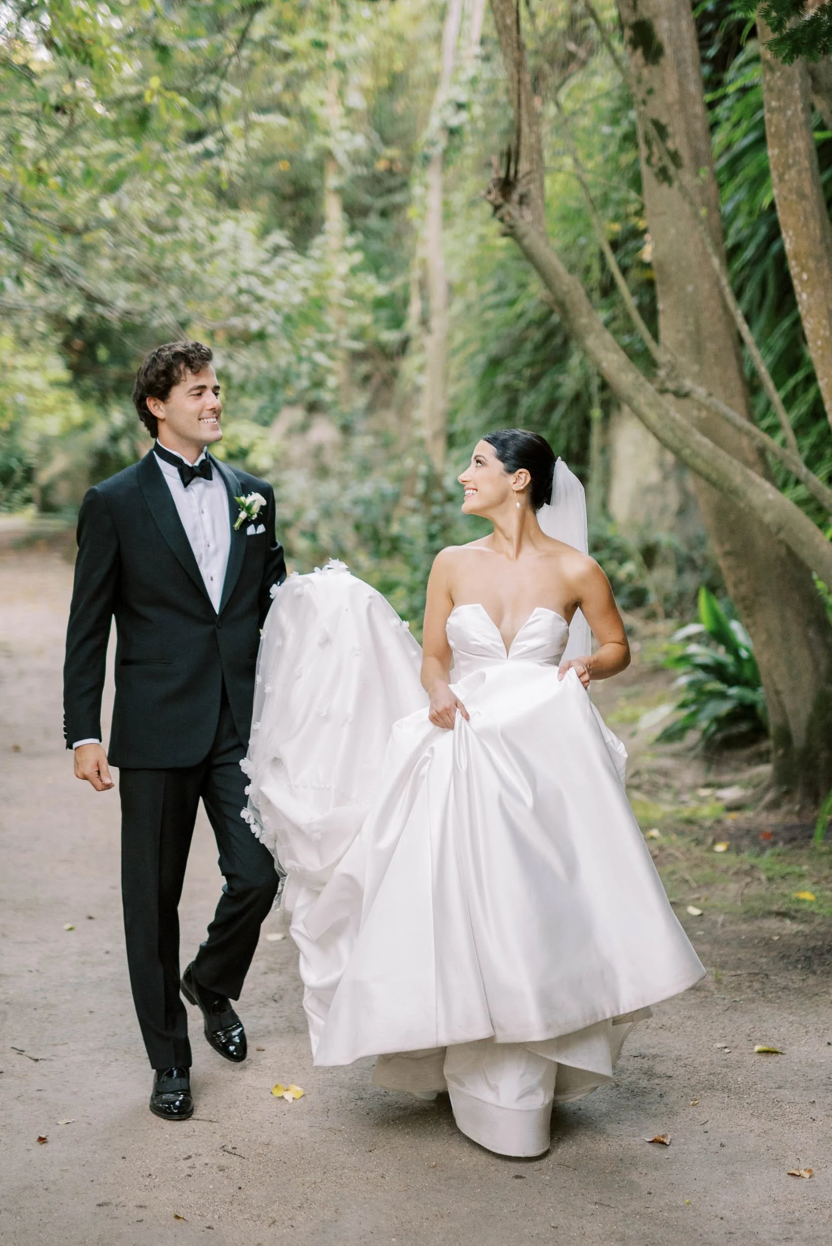 Bride and groom walking together in the gardens of Casa dos Penedos in Sintra