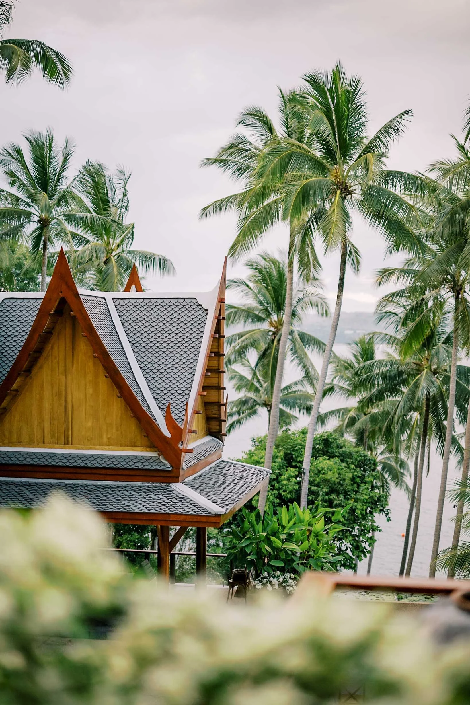 Thai architecture and palm trees at Amanpuri in Phuket, Thailand