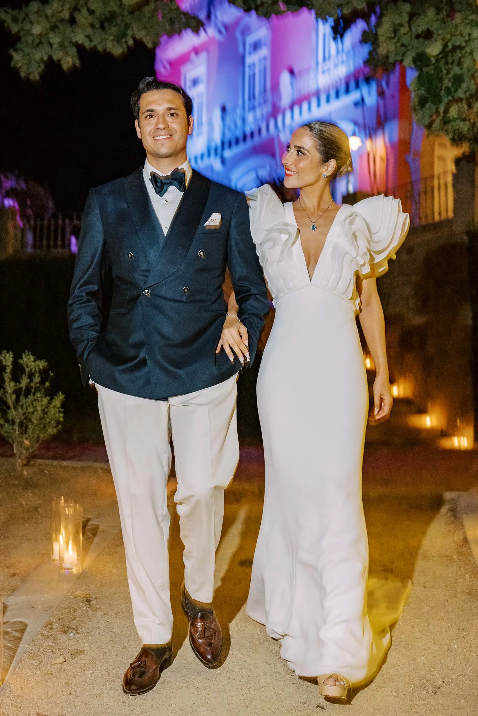 Bride and groom walking together at night during a wedding at Vidago Palace Hotel in Portugal