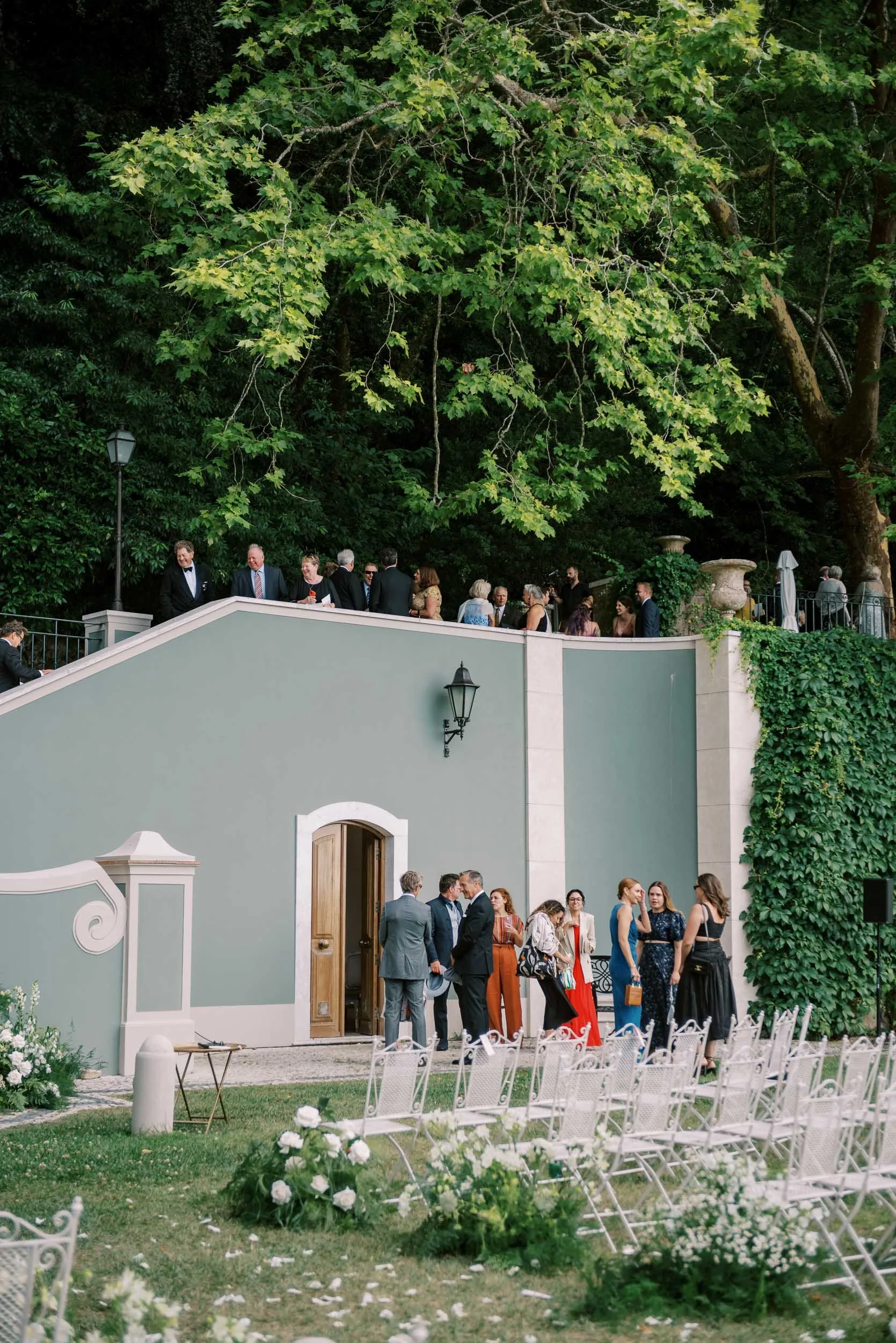 Wedding guests gathered above the ceremony area at Quinta da Bella Vista in Sintra, Portugal