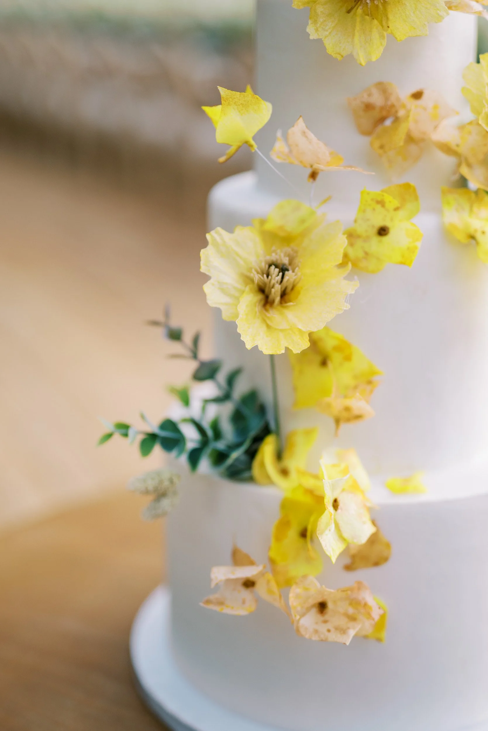 Wedding cake detail with yellow flowers at Quinta da Bella Vista in Sintra, Portugal