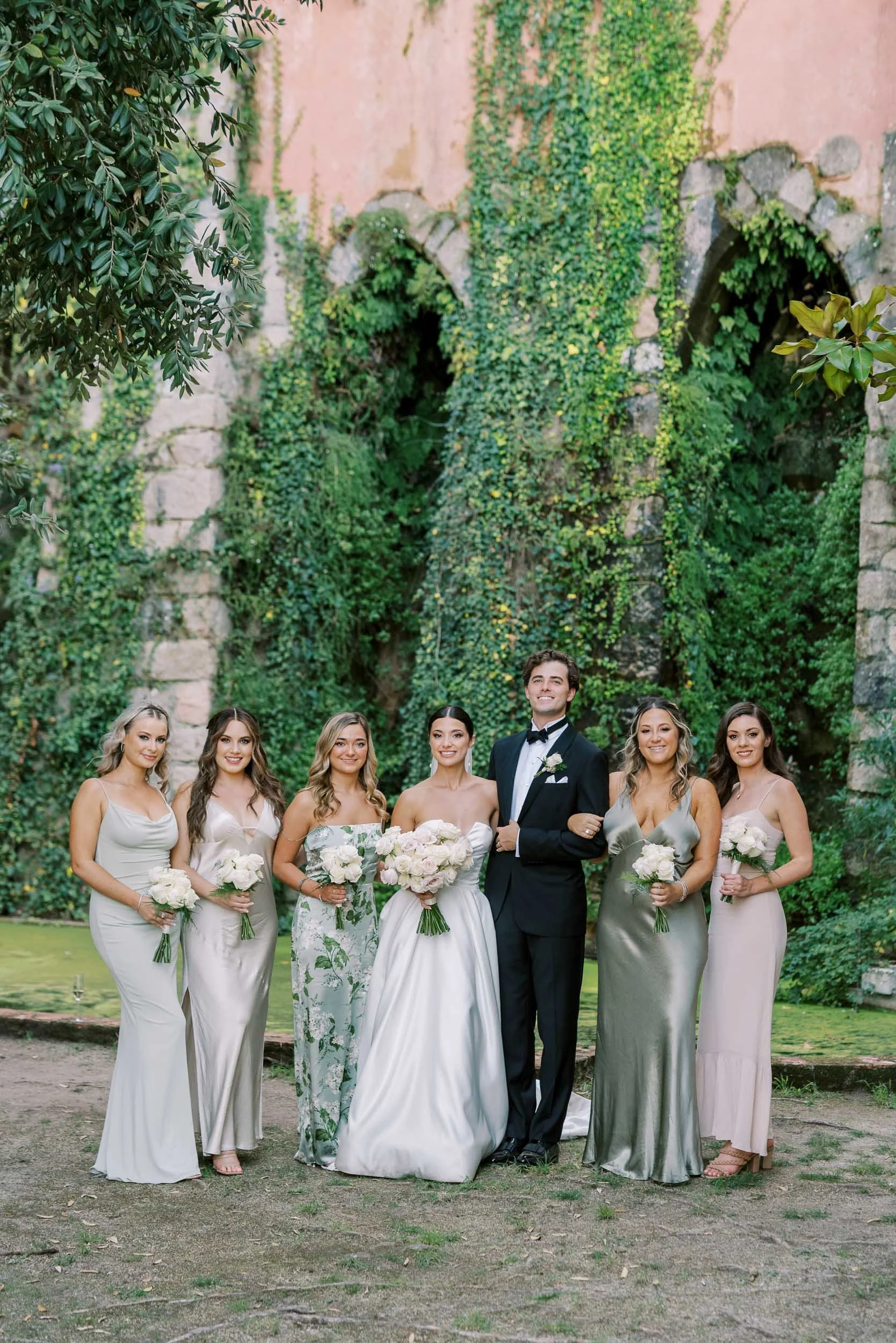 Bride and groom with wedding party in the gardens of Casa dos Penedos in Sintra