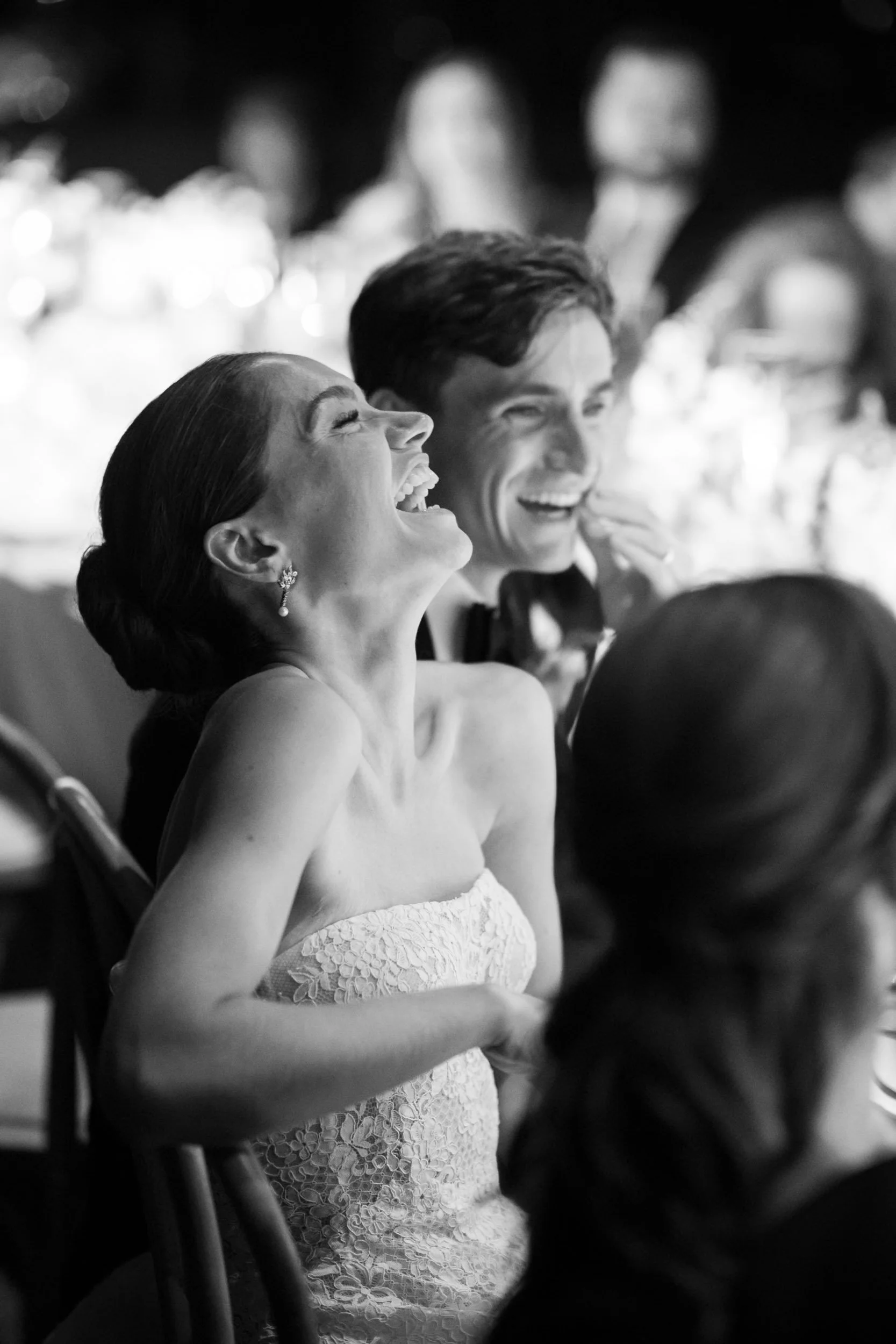 Bride and groom sharing a joyful moment during the wedding dinner