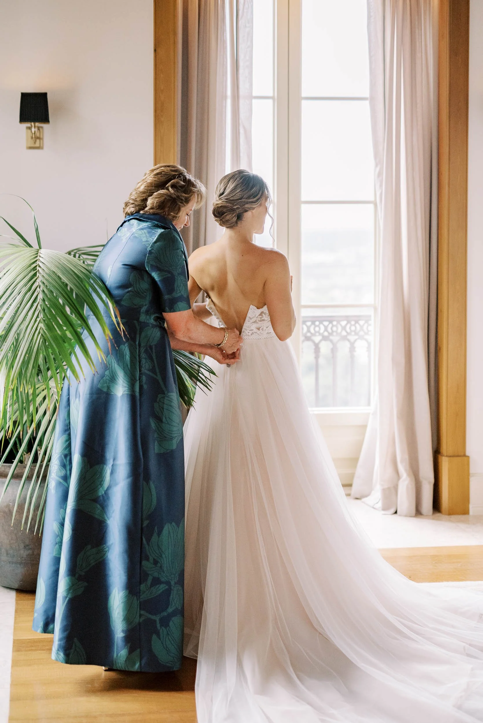Bride getting ready with help into her wedding dress at Quinta da Bella Vista in Sintra, Portugal