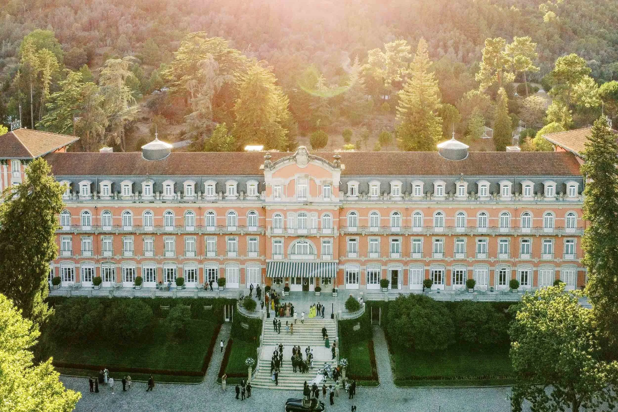 Drone view of Vidago Palace Hotel during cocktail hour at sunset in Portugal