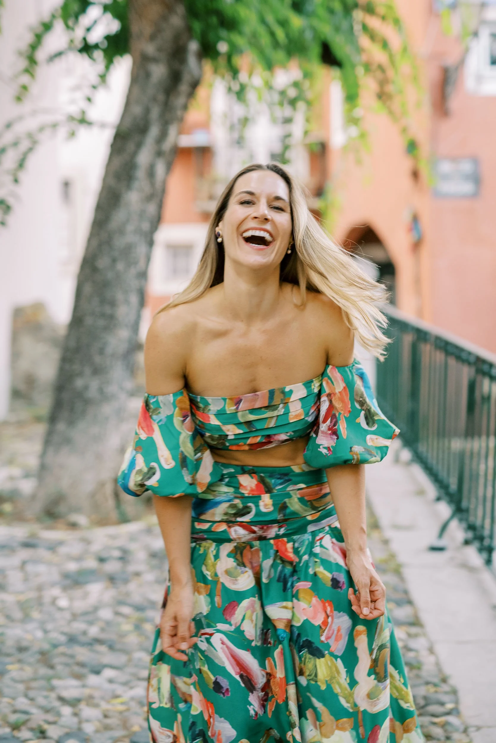 Wedding guest laughing outdoors during the celebration