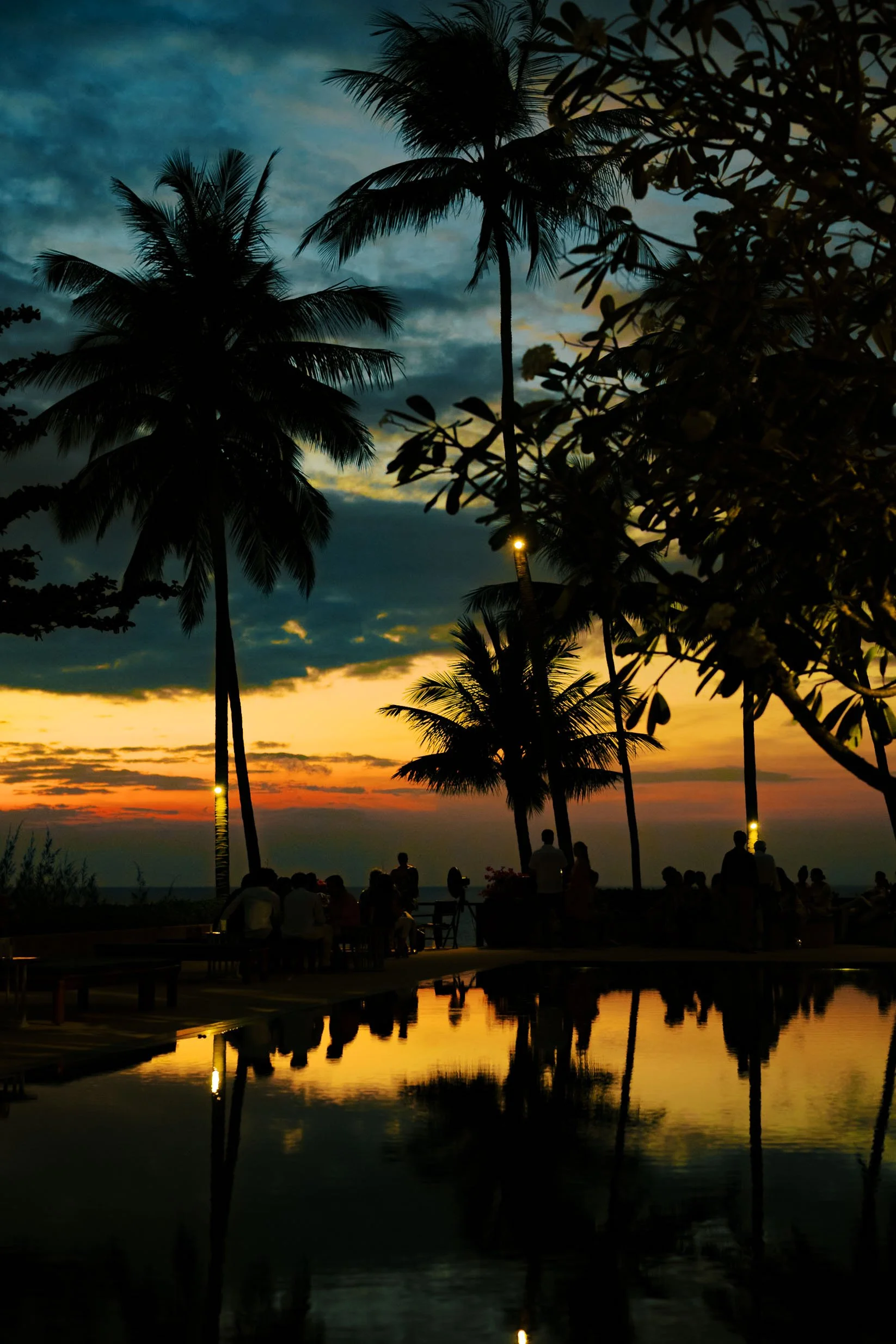 Evening sky glowing red through the palm trees at Amanpuri in Phuket, Thailand