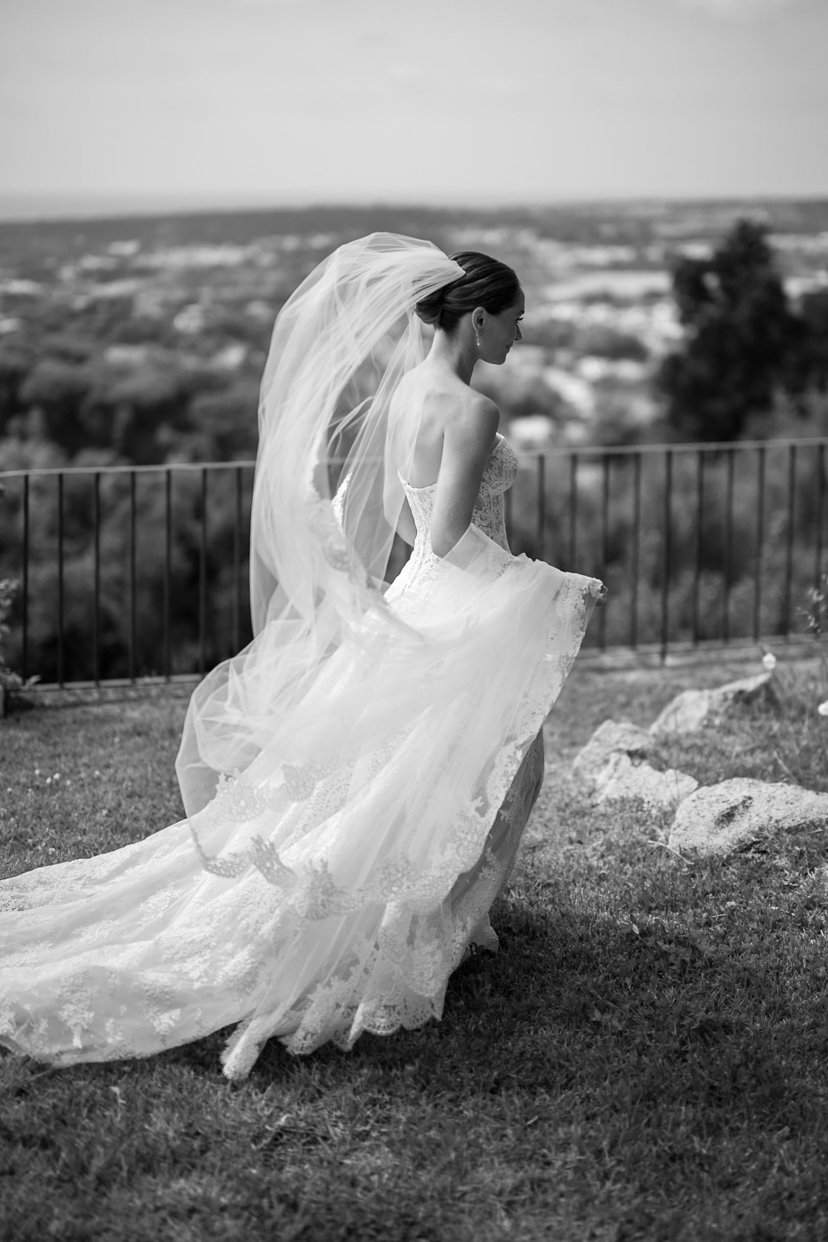 Bride walking outdoors in her wedding dress and veil during the celebration