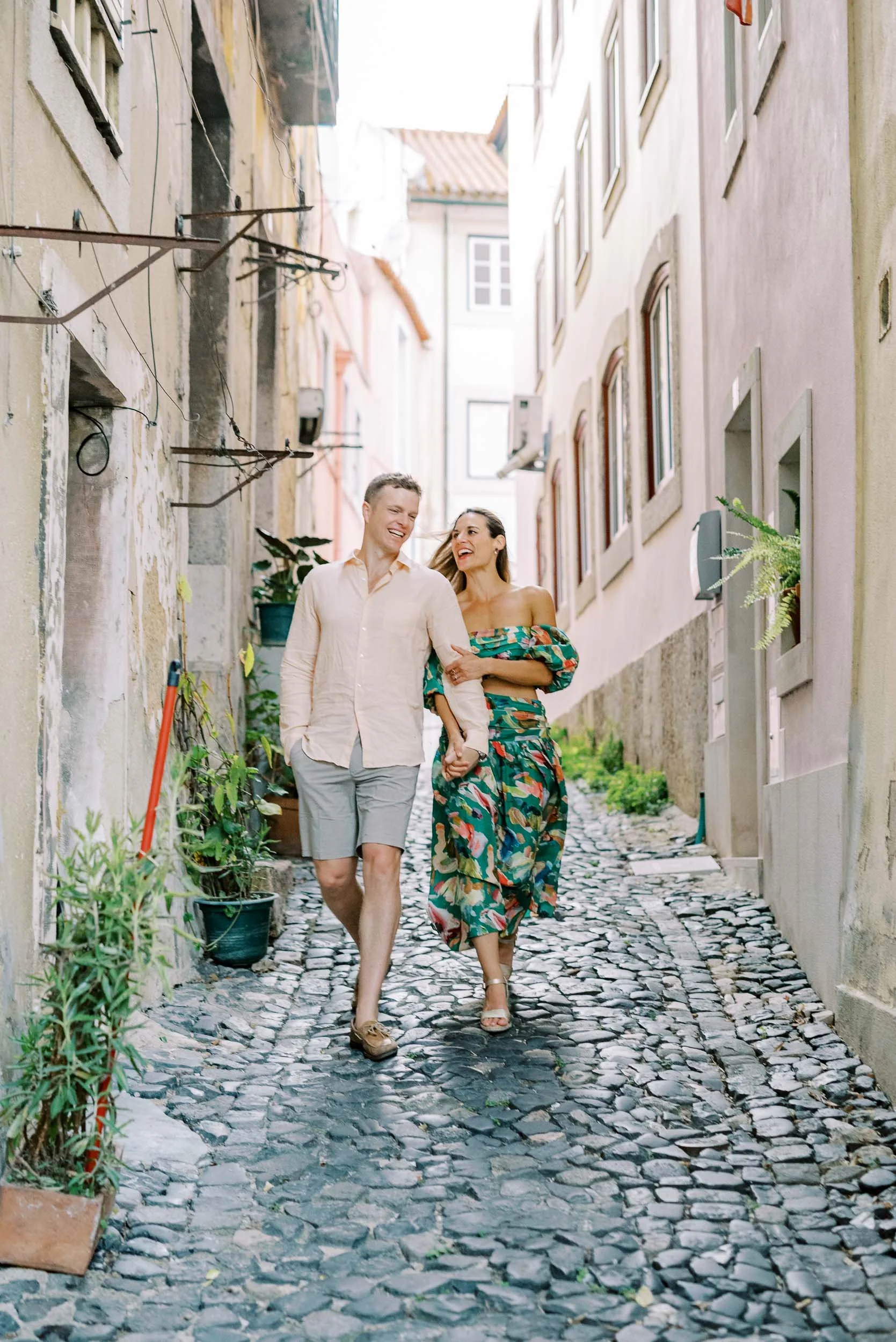 Engagement-style couple portrait in the narrow streets of old Lisbon before a wedding at Quinta da Bella Vista in Sintra, Portugal