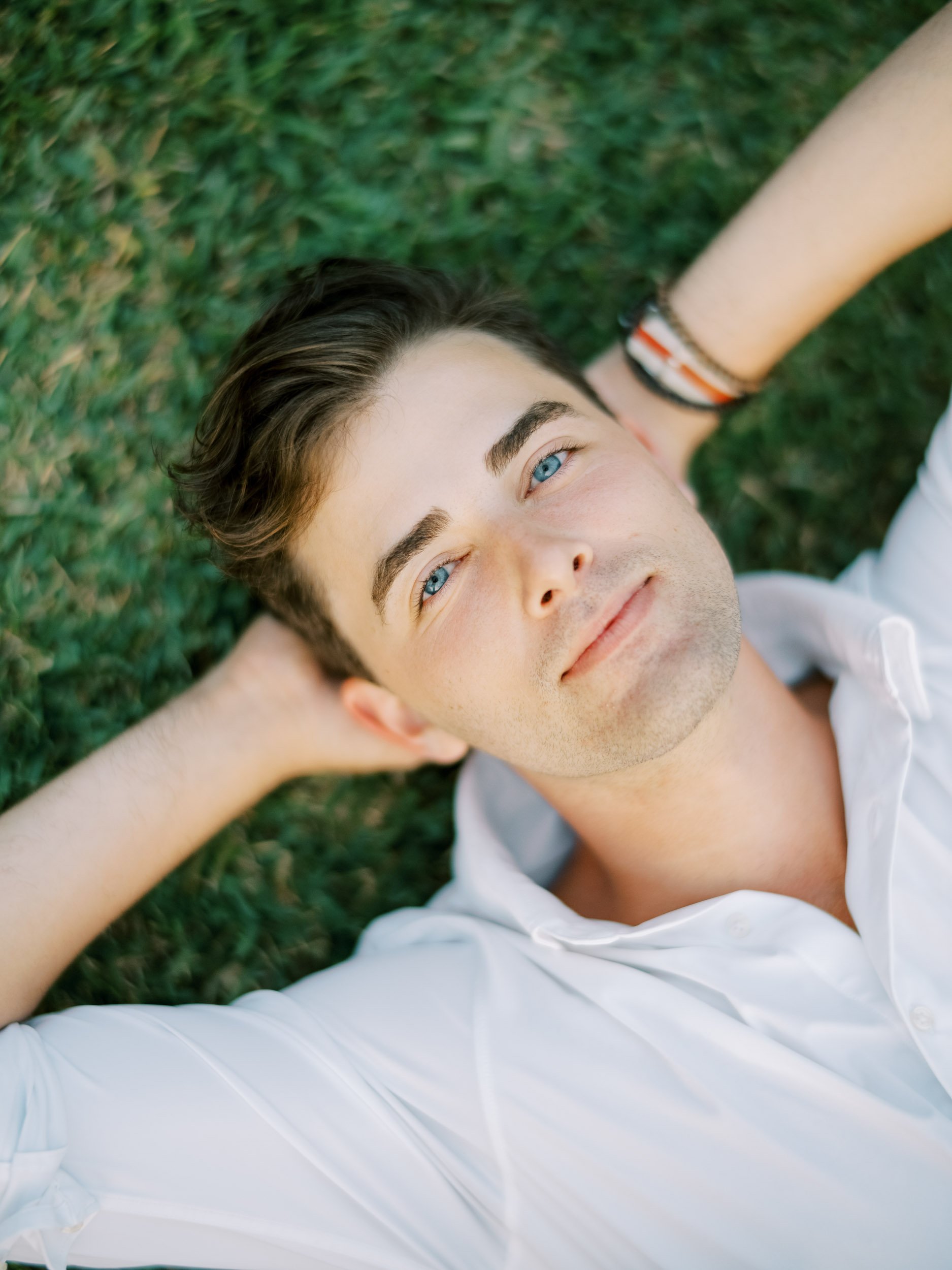 Groom portrait lying on the grass at the Palace of Monserrate in Sintra