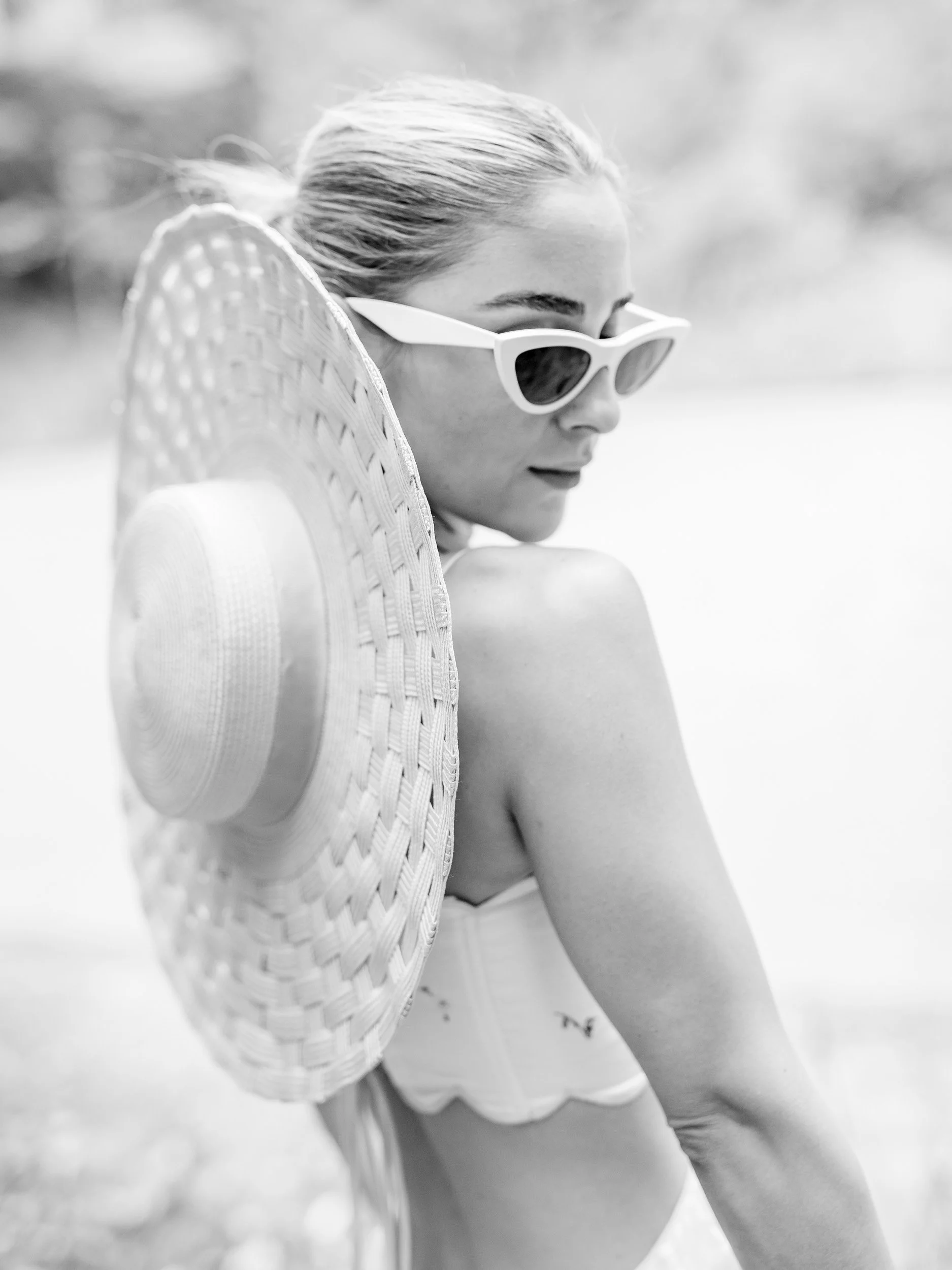 Bride portrait with hat and sunglasses outdoors during a wedding at Vidago Palace Hotel in Portugal