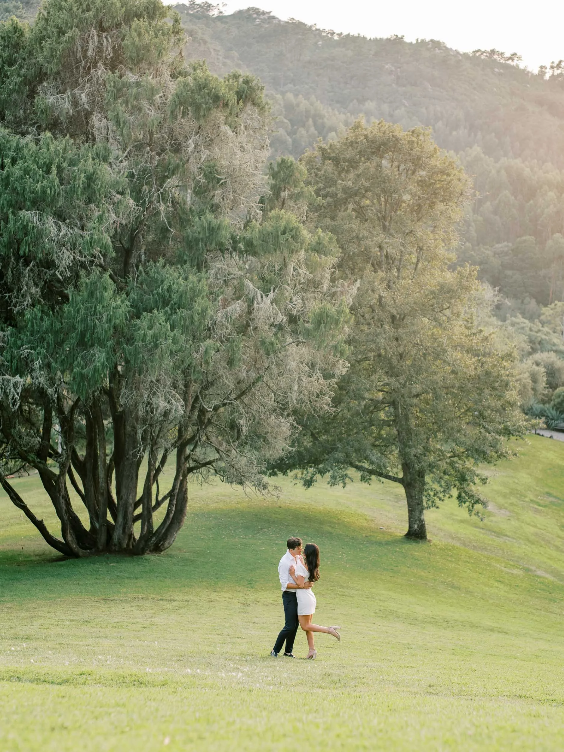 Couple sharing a kiss on the grounds of the Palace of Monserrate in Sintra