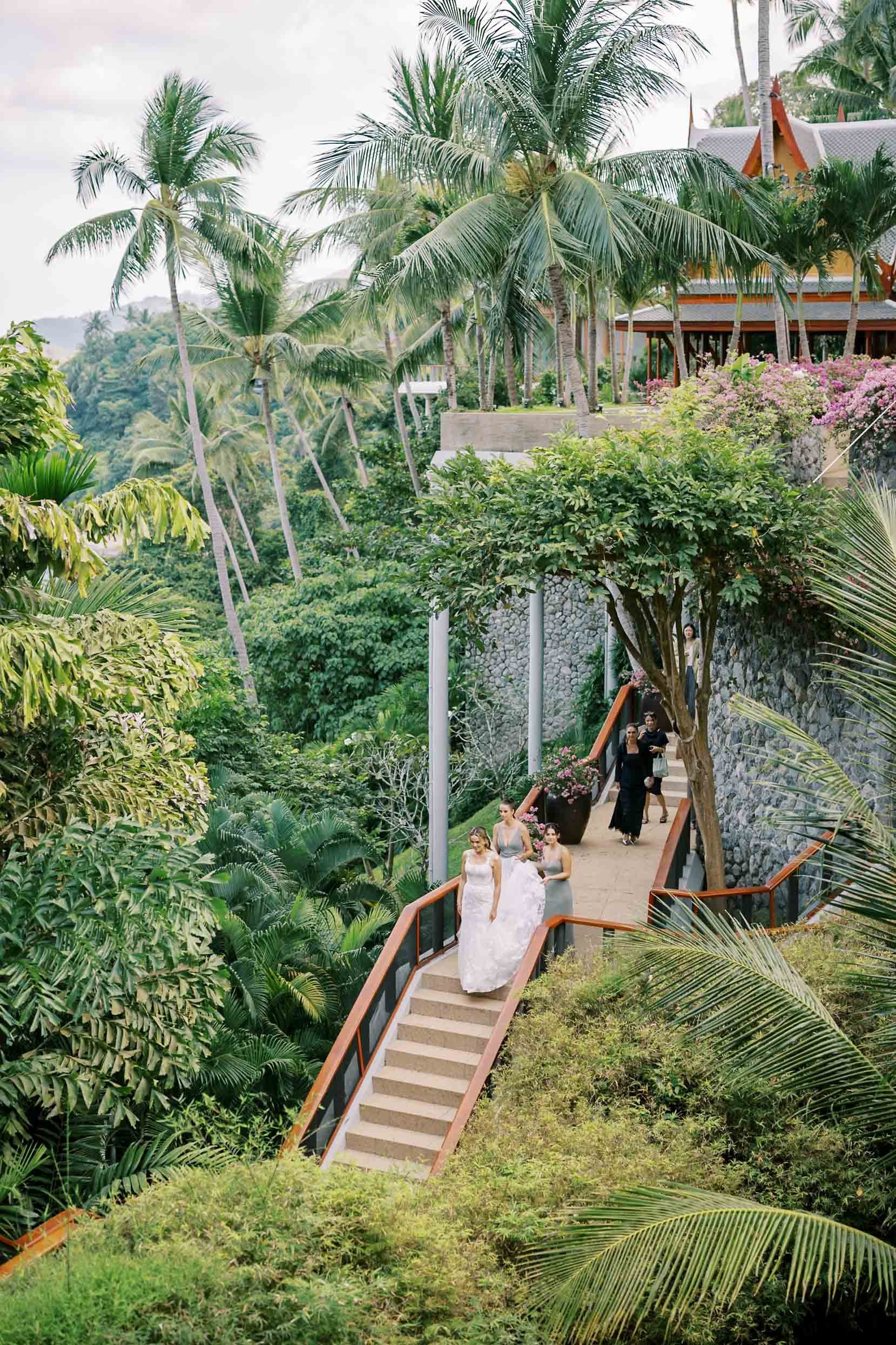 ride being helped by her bridesmaids on the way to the first look at Amanpuri in Phuket, Thailand