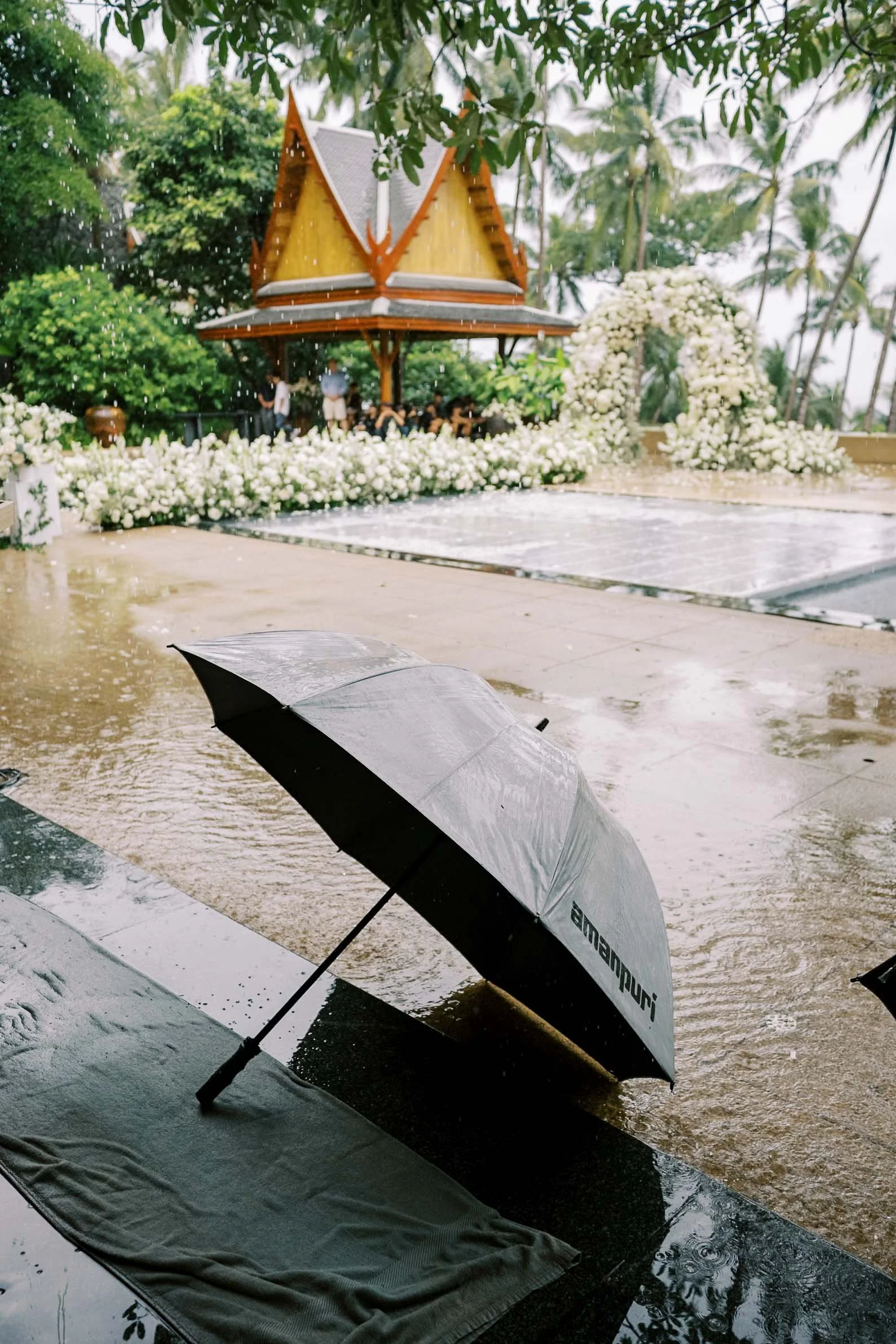 Umbrella waiting in the rain before the ceremony at Amanpuri in Phuket, Thailand