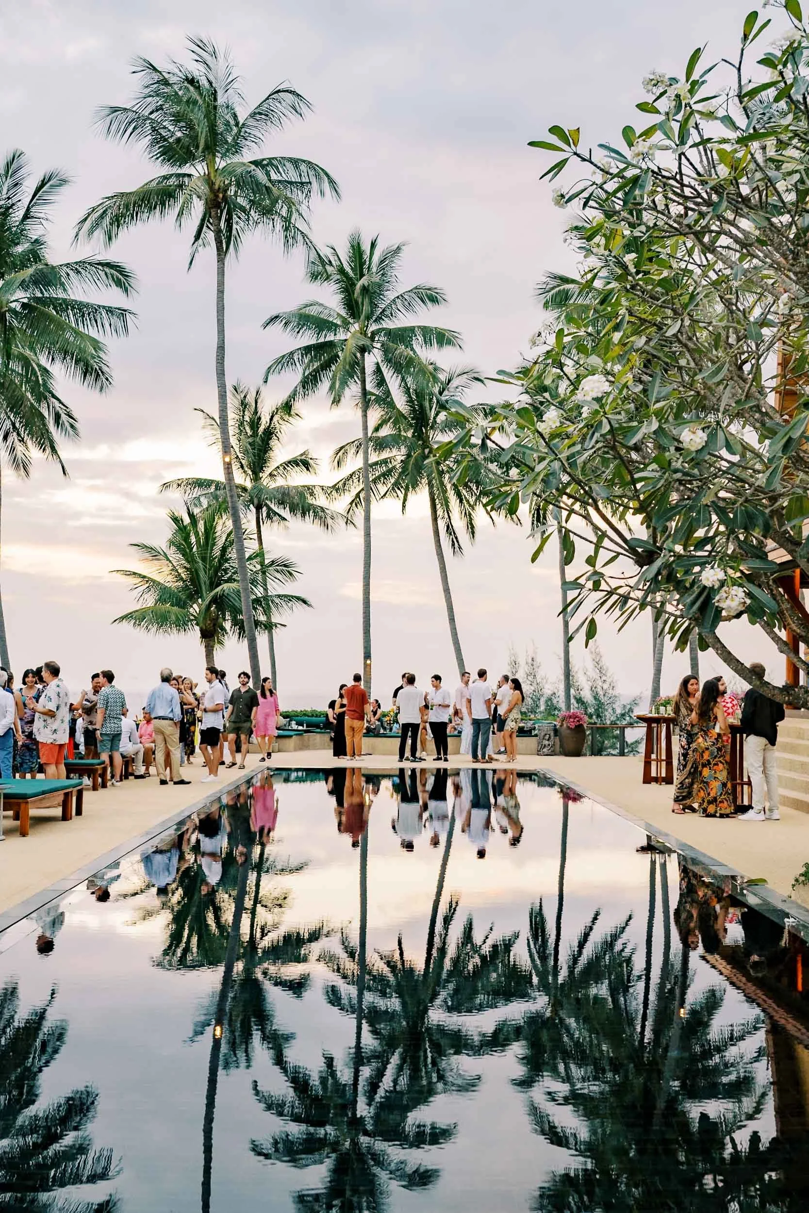 Palm trees reflected in the pool during the welcome celebration at Amanpuri in Phuket, Thailand