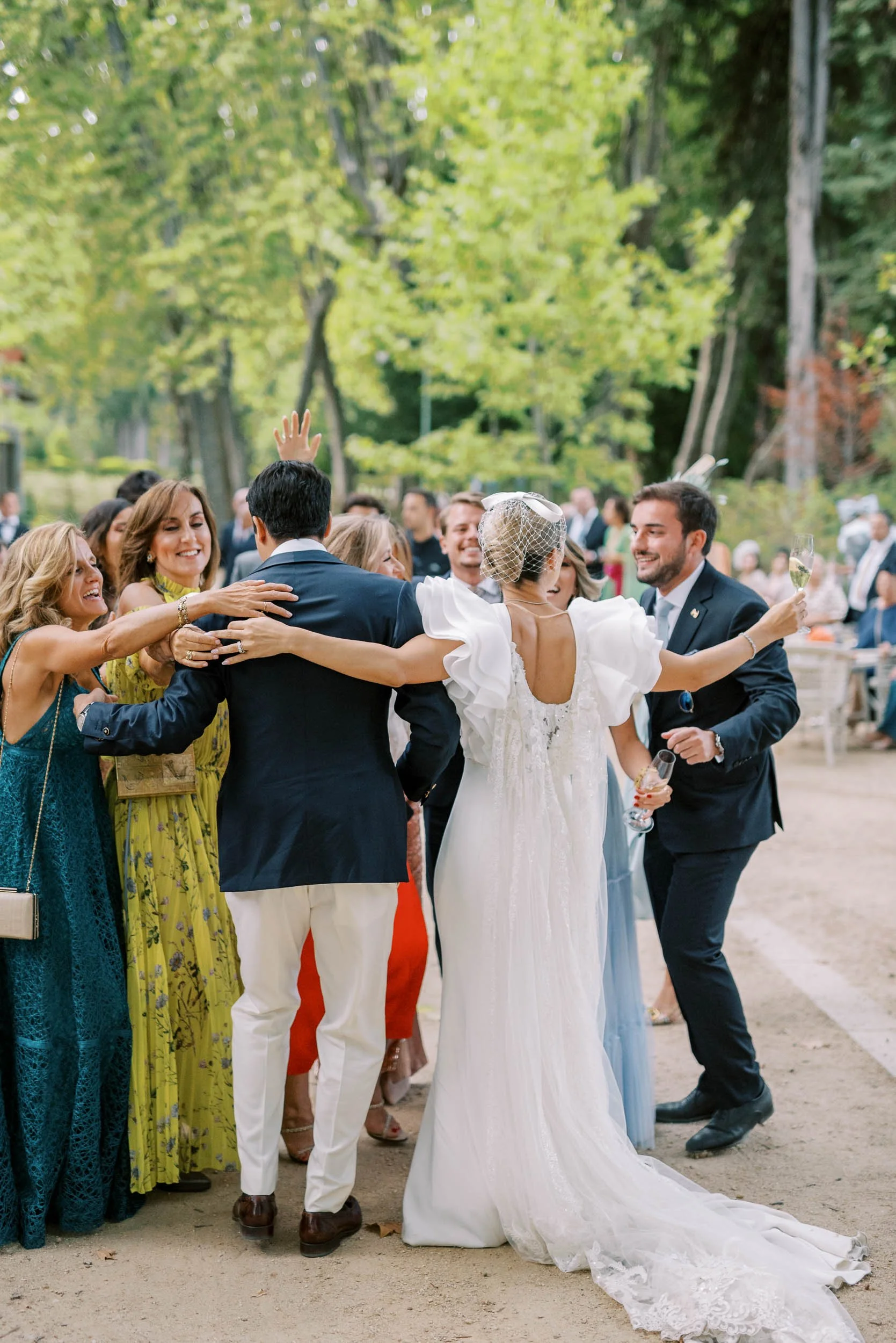 Bride and groom hugging guests during a wedding at Vidago Palace Hotel in Portugal