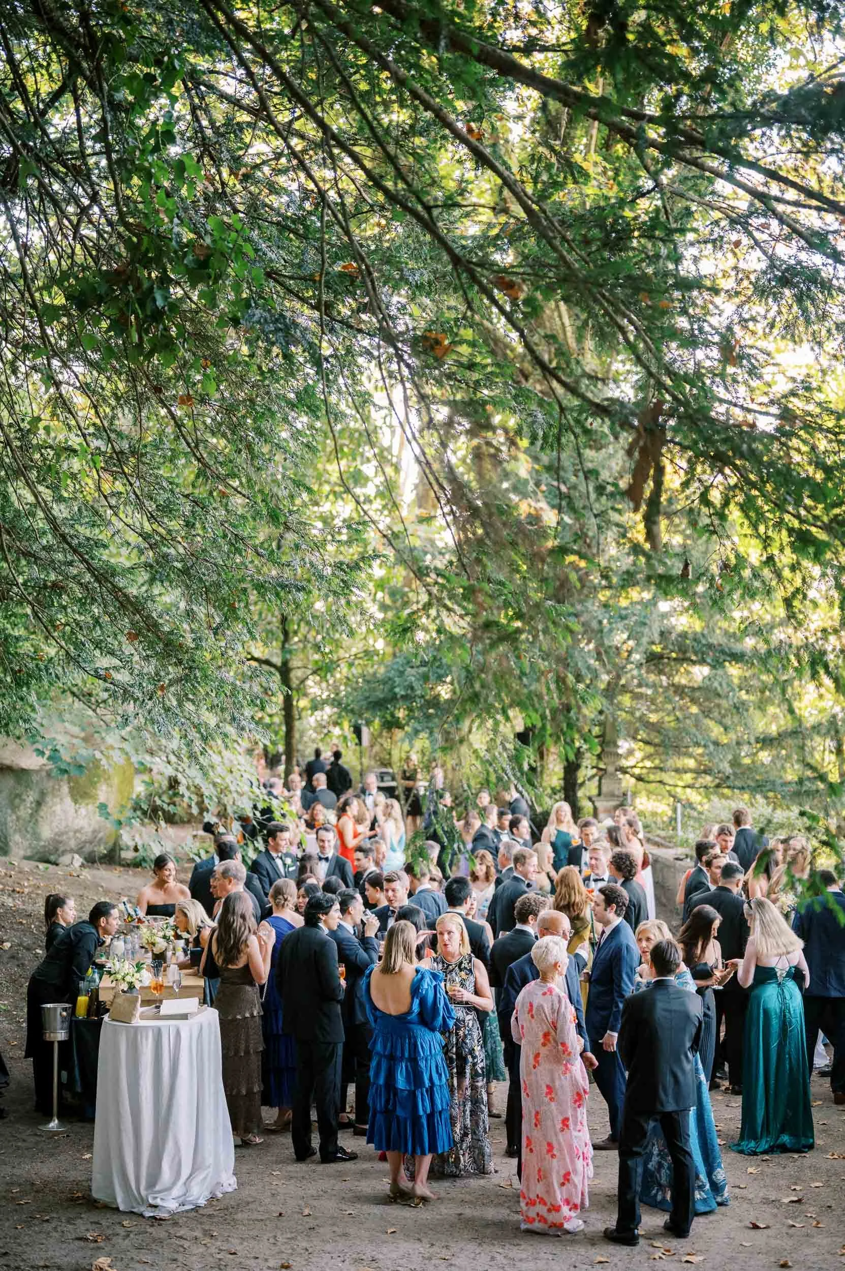 Wedding guests during cocktail hour in the gardens of Casa dos Penedos in Sintra