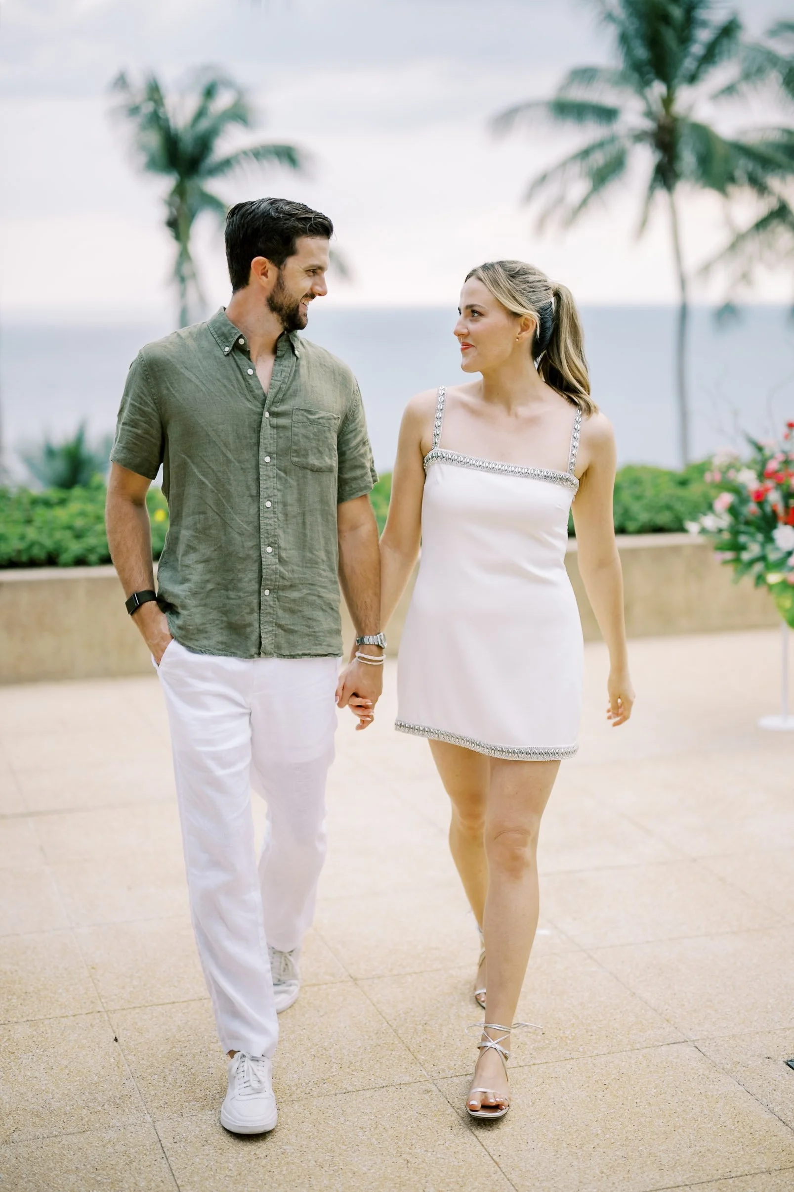 Bride and groom walking together during their destination wedding at Amanpuri in Phuket, Thailand