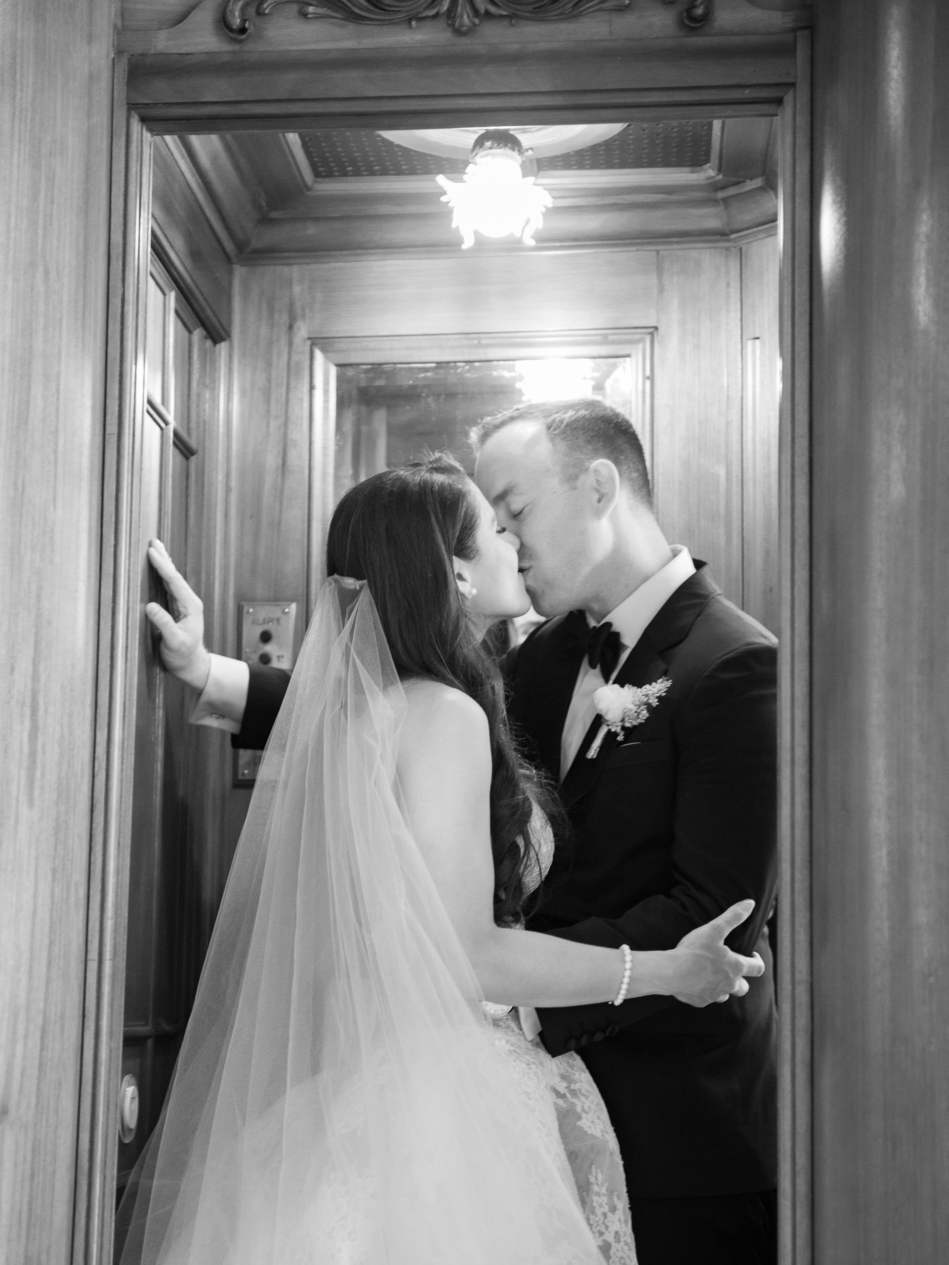 Bride and groom kissing in the elevator at Pestana Palace in Lisbon, Portugal