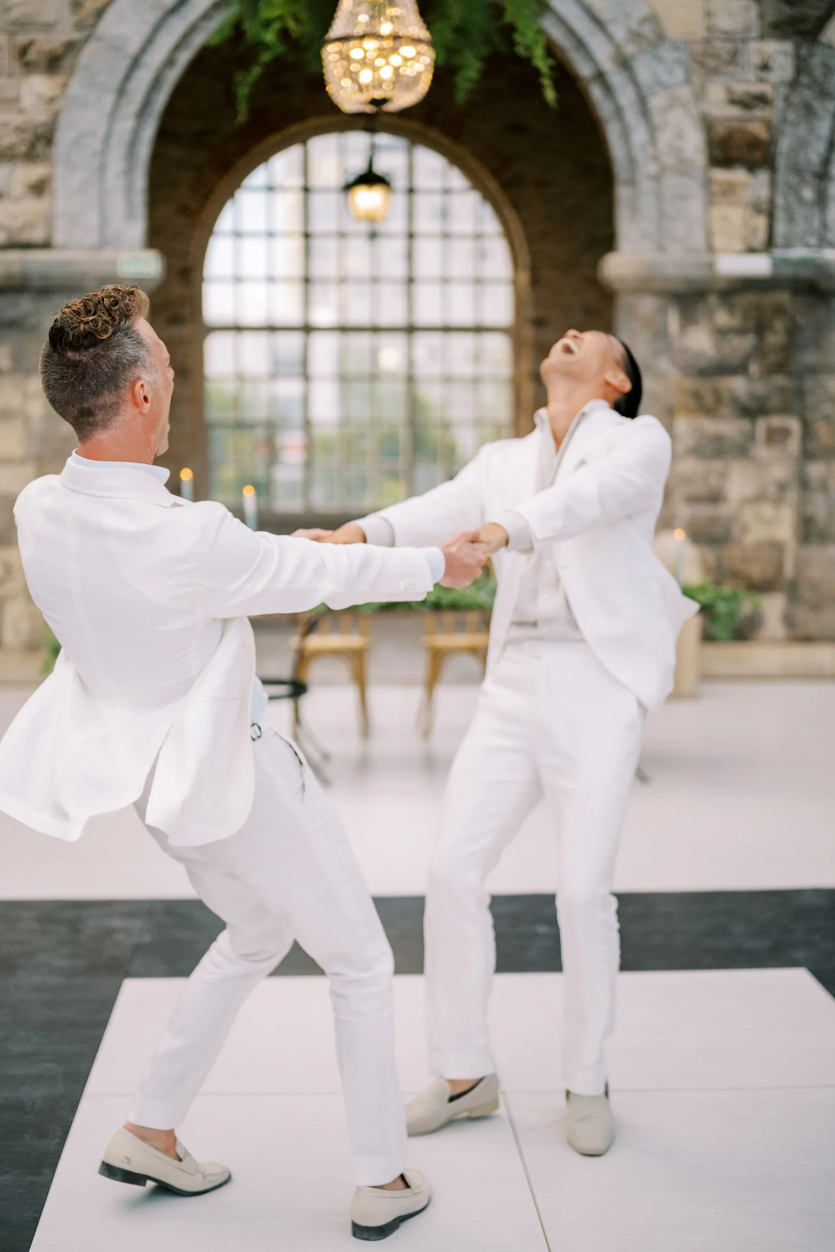 Two grooms dancing at Forte da Cruz in Estoril, Portugal